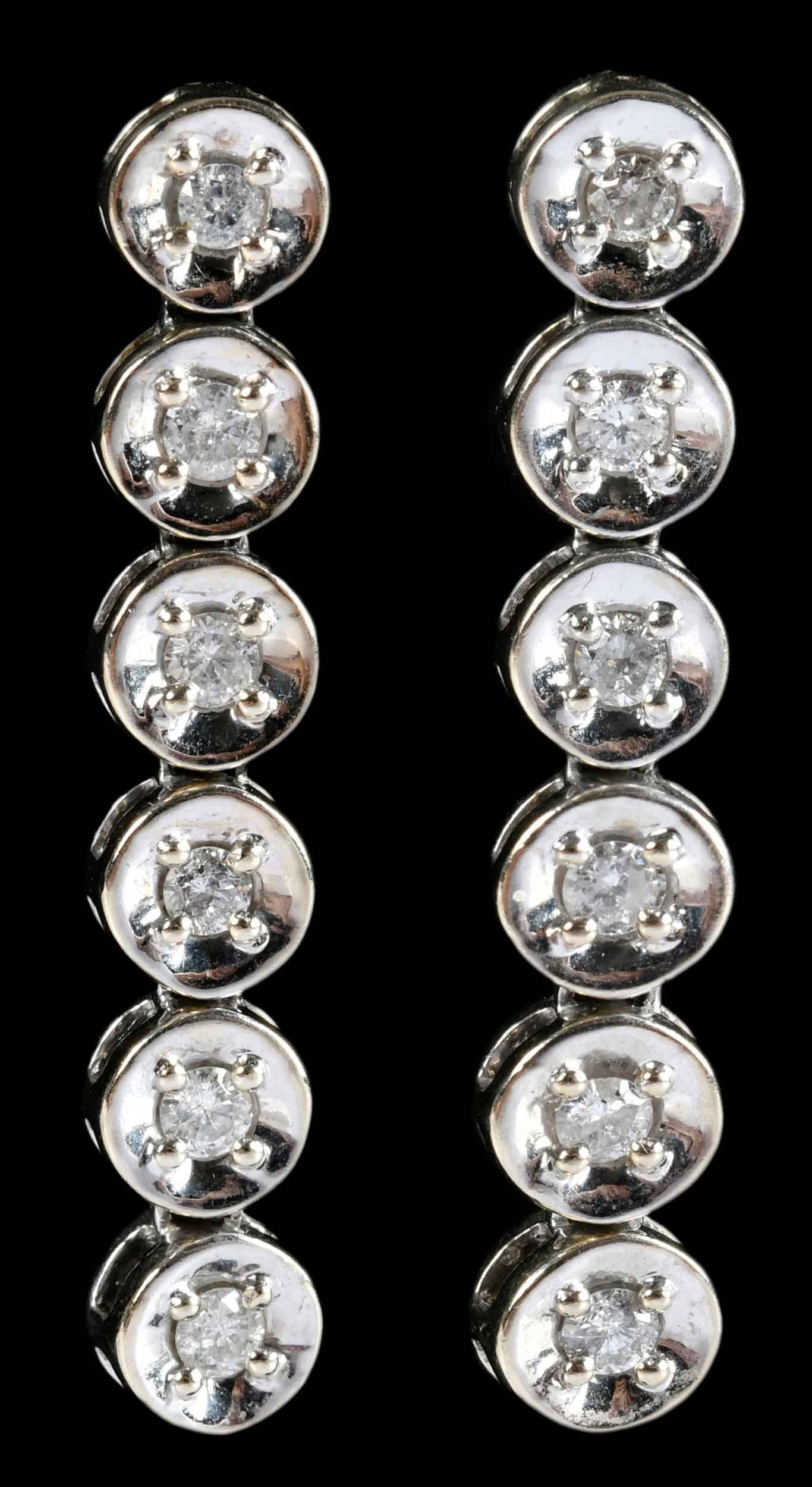 14kt. Diamond Line Drop Earrings: 12 round faceted diamonds, approx. 1.00ctw., SI-I, H-I, marked "14K", white gold, 1-1/2 in. length, 7.0mm wide, 9.7 g Provenance: Private Collection, Virginia Beach Note: Brunk Auctions makes no warra