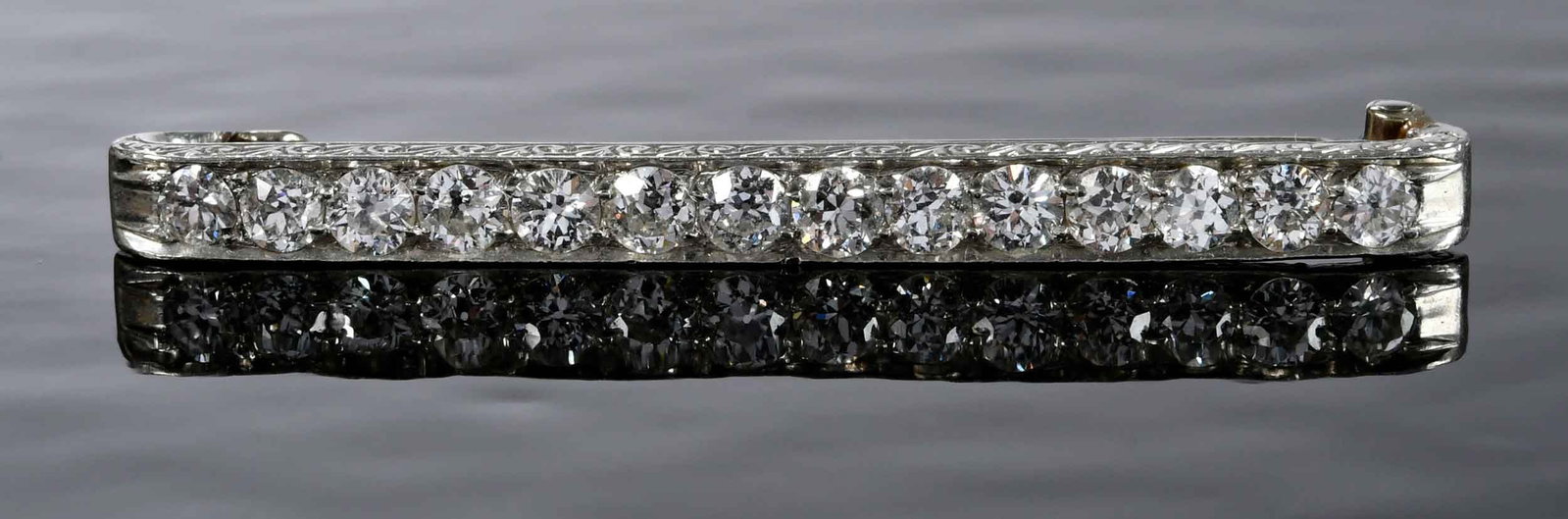 Platinum Diamond Bar Pin: 14 round faceted diamonds, approx.1.50ctw., tested platinum, 1-7/8 in. length, straight pin tests 14kt. white gold, 4.0mm width, 5.8 g Provenance: Lifetime Collection of a Granville, Ohio Collector No