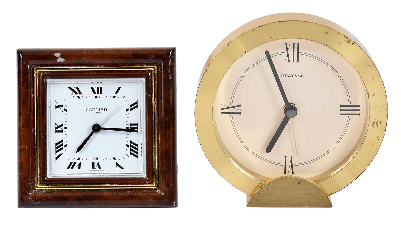 Two Small Desk Clocks, Tiffany and Cartier: American and French, 20th century, comprising: round Tiffany & Co. clock, marked "... Swiss quartz/10738", 3-5/8 x 3-1/2 x 1-1/8 in.; square Cartier clock, marked "7503 07848/Swiss Made", 3 x 3 x