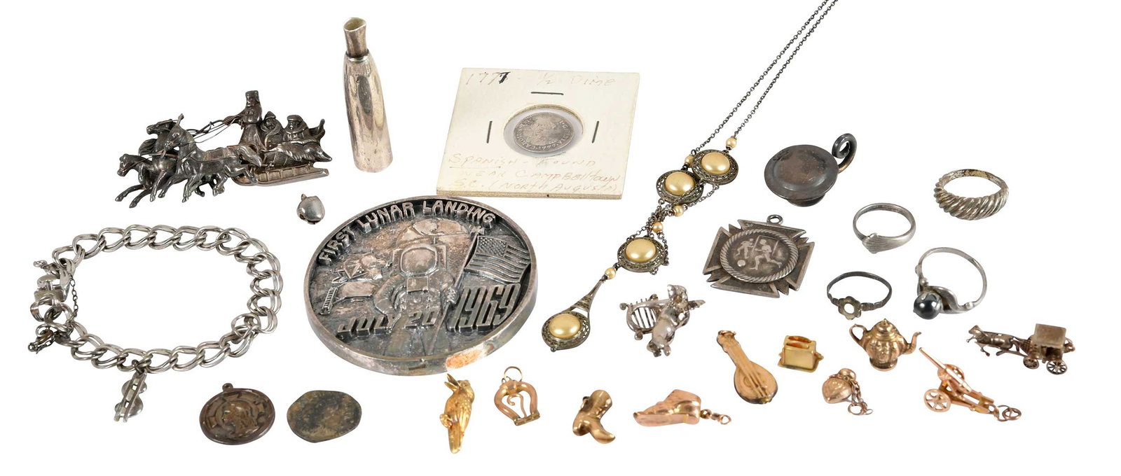28 Pieces Assorted Silver and Gold Jewelry and Trinkets: 19th/20th century, including seven 10kt. yellow gold charms (toaster, cannon, cage coach, shoe, boot, bird, mandolin), 10.7 grams; three gold plate charms; Russian silver pin with figural horse driven