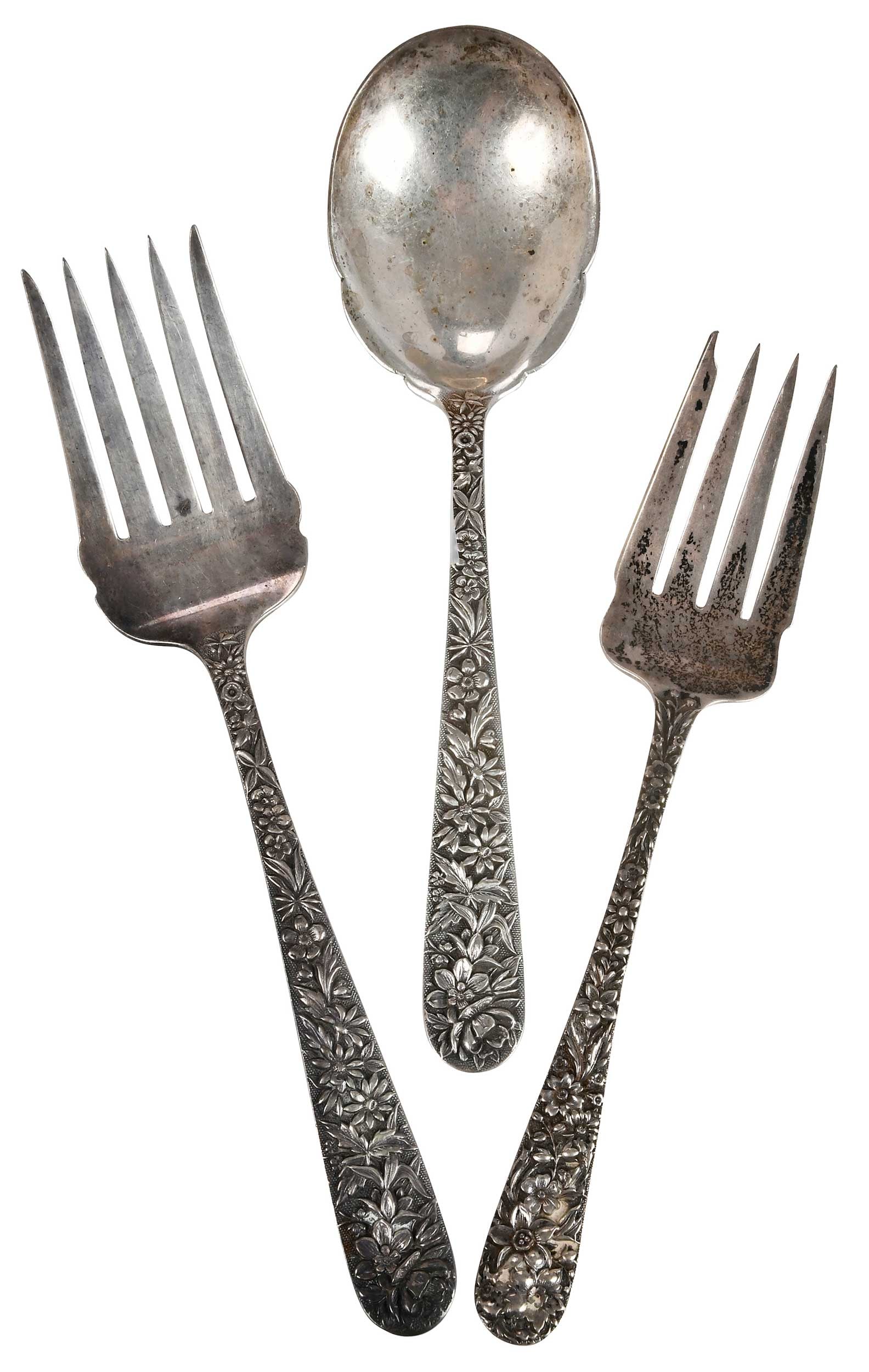 Three Kirk Repousse Sterling Serving Pieces: Baltimore, 20th century, floral repousse handles, including two serving forks and one serving spoon, no monogram, marks for S. Kirk & Son, 9.19 oz. T., 8-1/2 in. to 9-1/8 in.