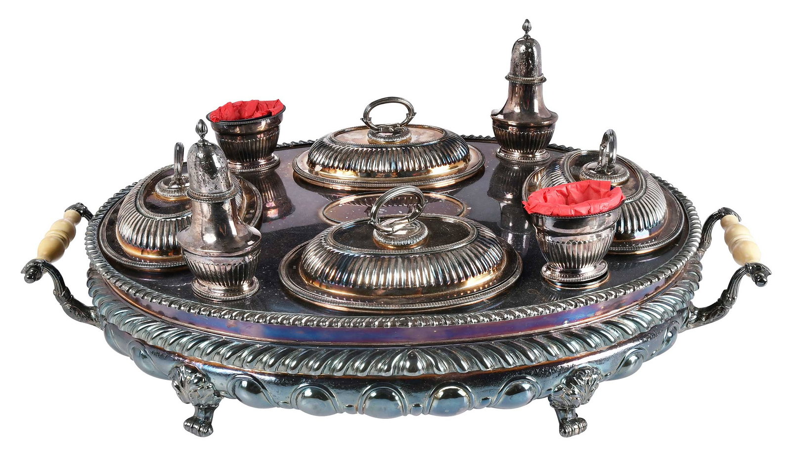 English Silver Plate Oval Buffet: 20th century, oval form with gadroon borders, ivory handles, urn form tureen with coat of arms, four entree, pair open salts with glass liners, and pair caster, 13 x 27 x 16 in. Provenance: Private