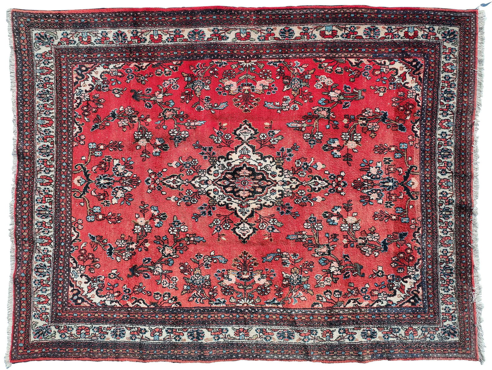 Sarouk Carpet: central medallion on red ground, white and blue spandrels, multiple borders, 11 ft. 8 in. x 9 ft. 9 in. Provenance: Private Collection, Pittsboro, North Carolina