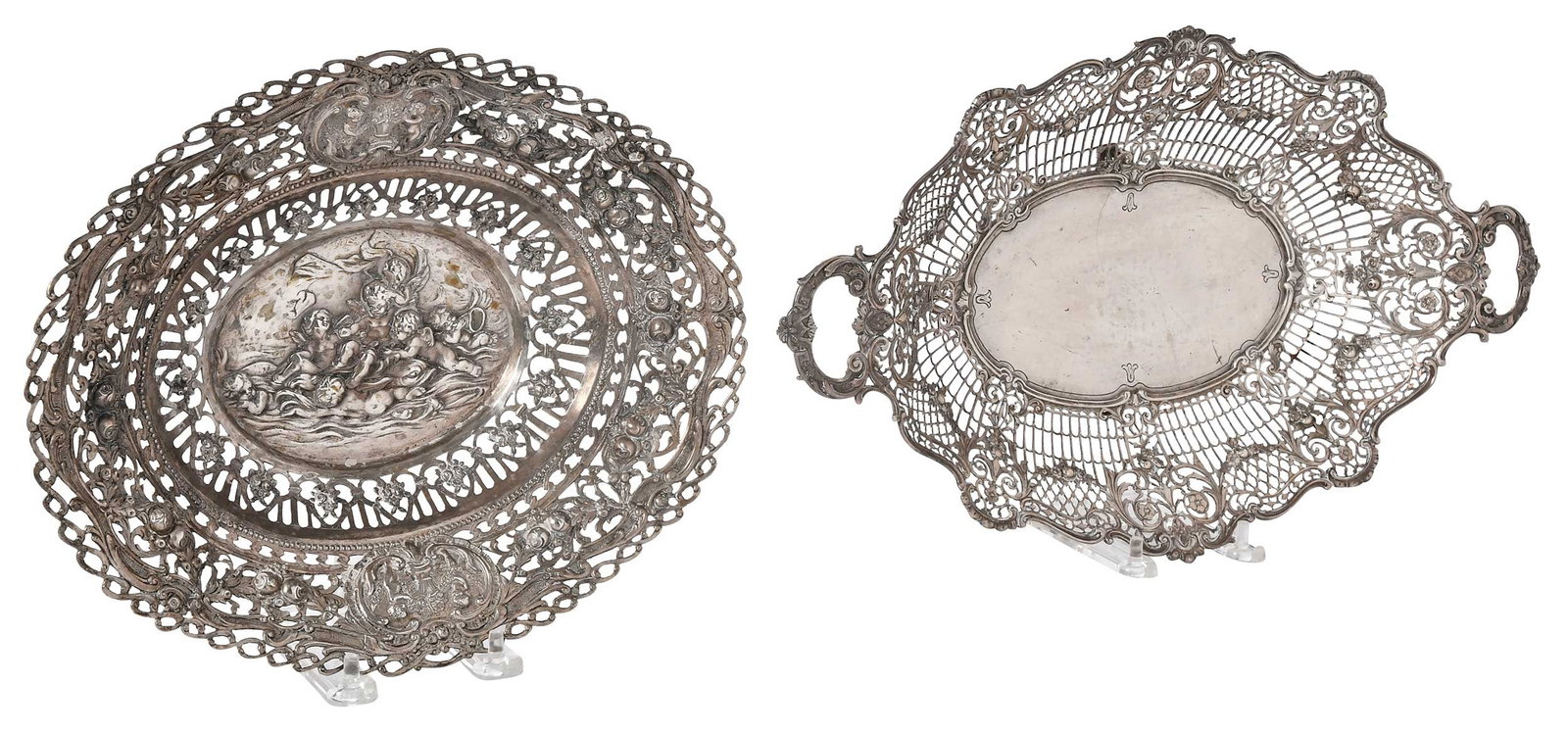 Two Openwork Oval German Silver Bowls: late 19th/20th century, one footed oval with handles, marks for Lazarus Posen, .800 fine, 2-1/4 x 15-1/2 x 9-1/4 in.; one oval with cupid and swag decoration, unmarked, test .900 or better, 2-1/4 x 11