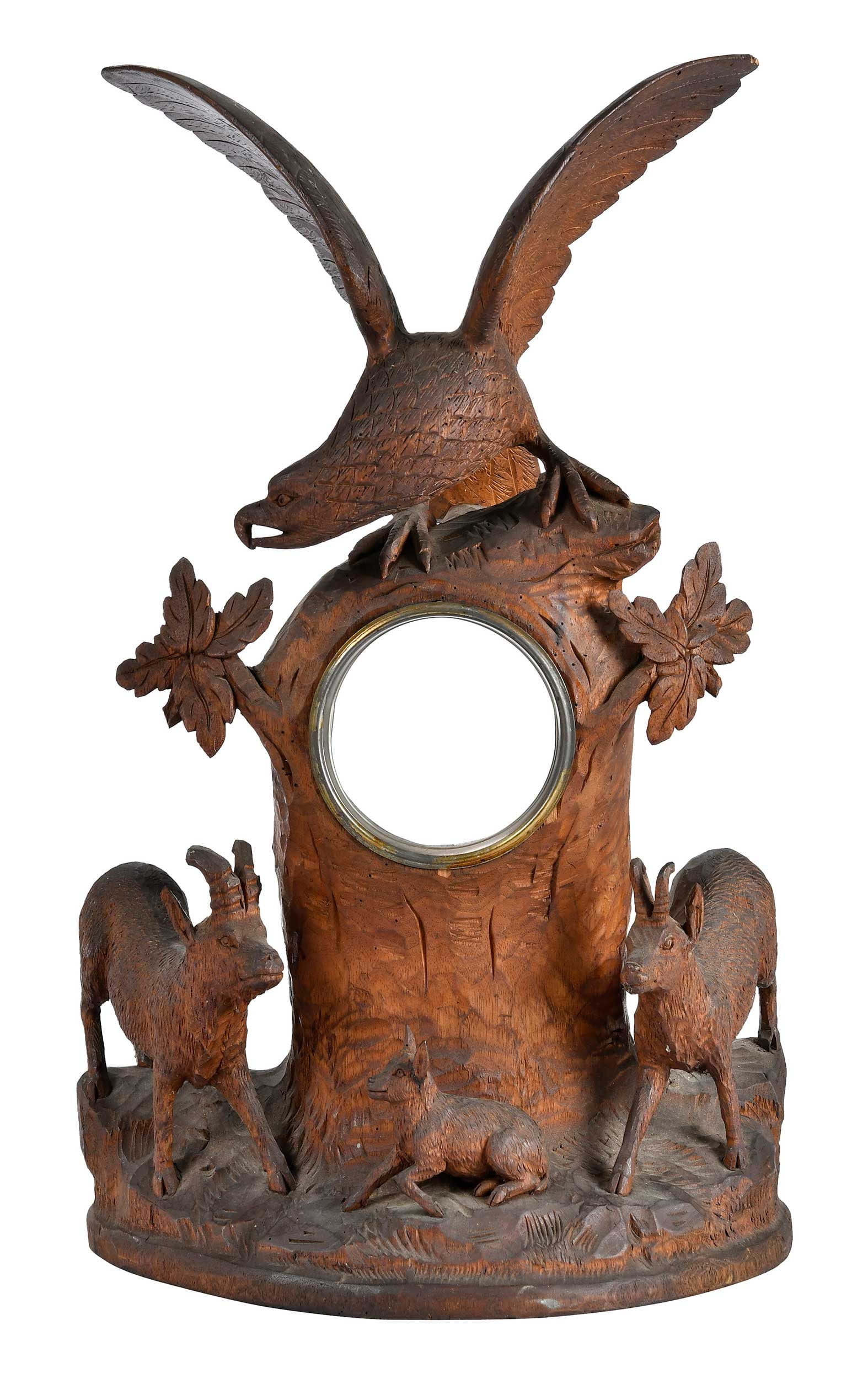 Black Forest Carved Wood Figural Mantle Clock Case: German, late 19th/20th century, depicting a spread wing eagle over a tree form case on naturalistic base with three ibexes, 20 x 12 x 7-1/2 in. Provenance: Collection of Steve Stewart, Lake Lure,