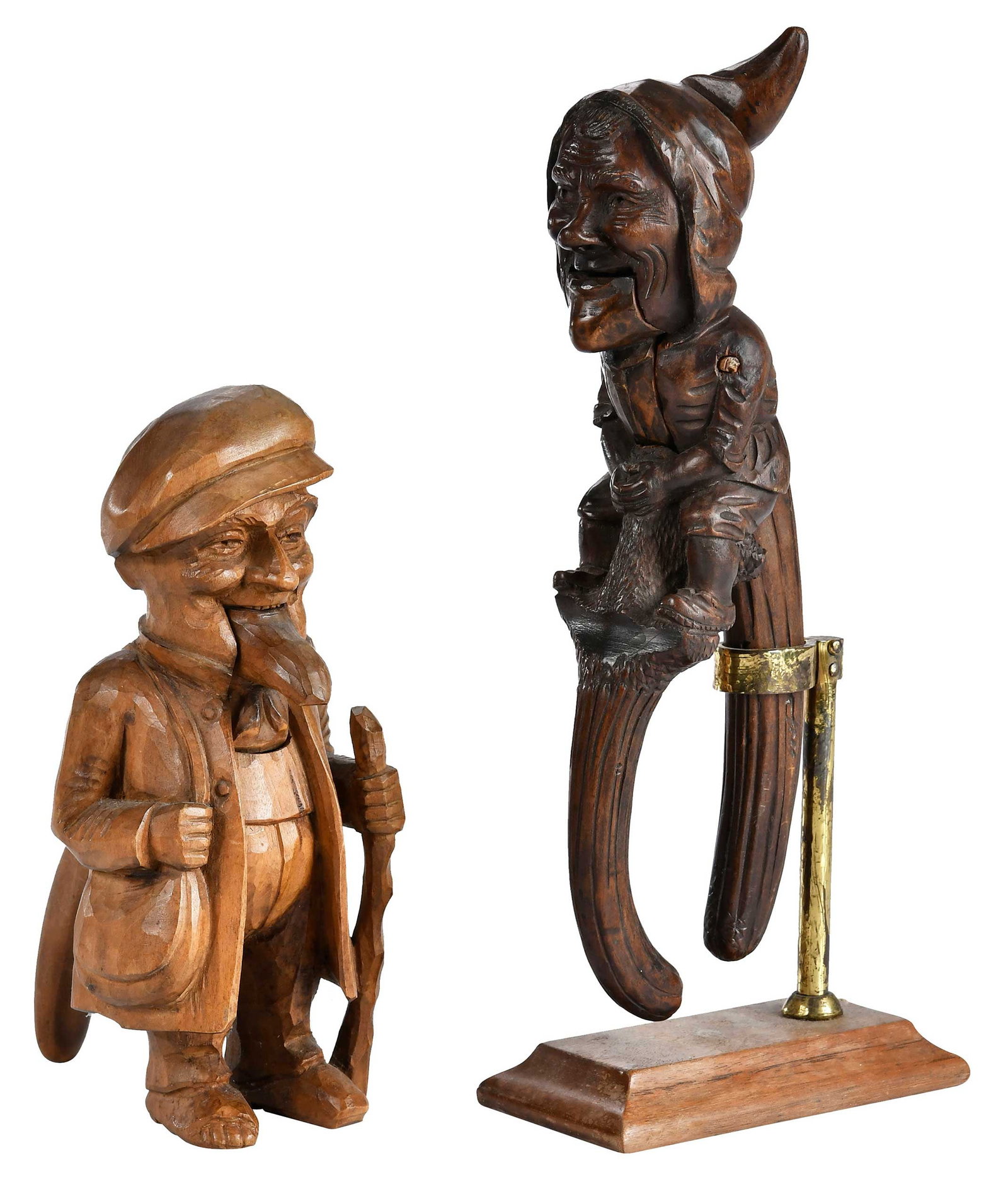 Two Black Forest Carved Figural Nutcrackers: German, late 19th/20th century, whimsically modeled in the form of two men, one free standing, one with metal holder on stand, larger 12 x 2-1/2 x 5 in. including stand Provenance: Collection of