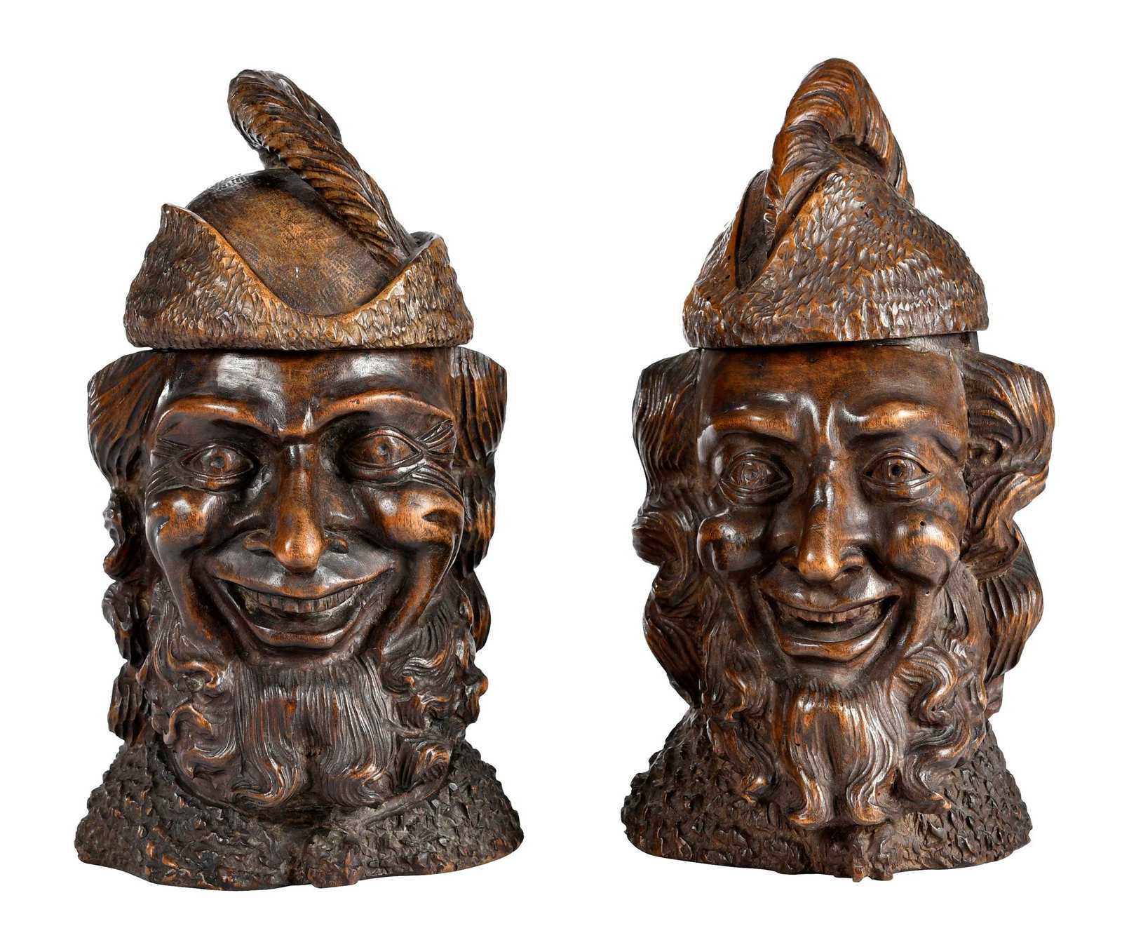 Two Black Forest Style Carved Wood Head Form Humidors: German, 20th century, grinning, bearded faces with hat form lids, each approx. 10-1/4 x 5-3/4 x 5-5/8 in. Provenance: Collection of Steve Stewart, Lake Lure, North Carolina