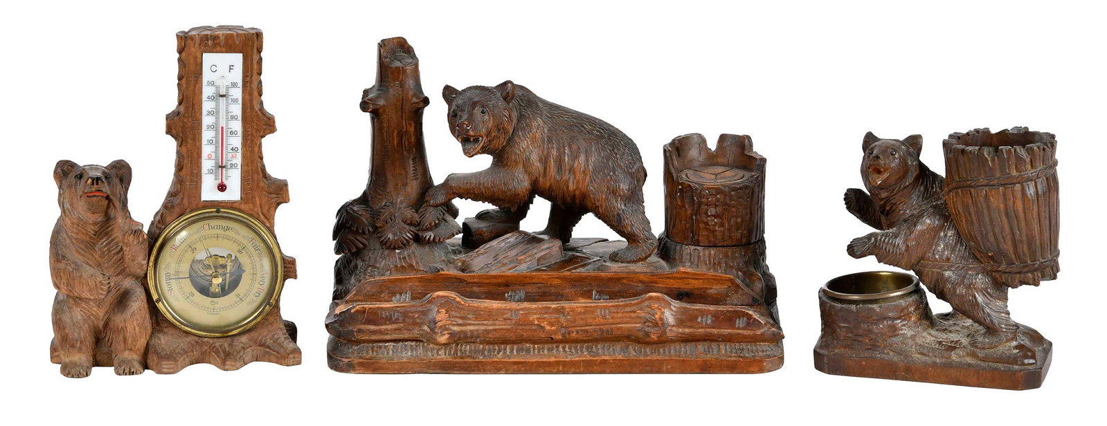 Three Black Forest Carved Bear Desk Accessories: German, 20th century, comprising: two inkstands/pen holders, one with brass liner, one with glass inkwell; desk thermometer/barometer; largest 7 x 10-5/8 x 5-1/2 in. Provenance: Collection of Steve St