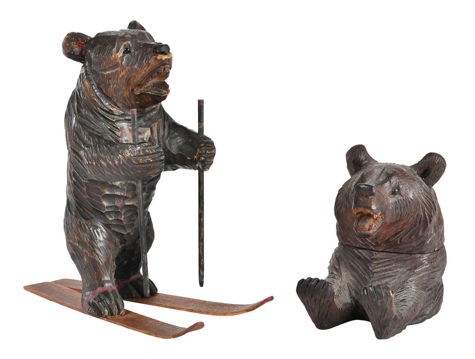 Two Black Forest Carved Bears: German, late 19th/20th century, bear figure on skis, 5-1/2 x 2-1/2 x 5-3/4 in.; bear pen holder and inkwell, 3-1/4 x 2 x 3-1/4 in. Provenance: Collection of Steve Stewart, Lake Lure, North Carolina