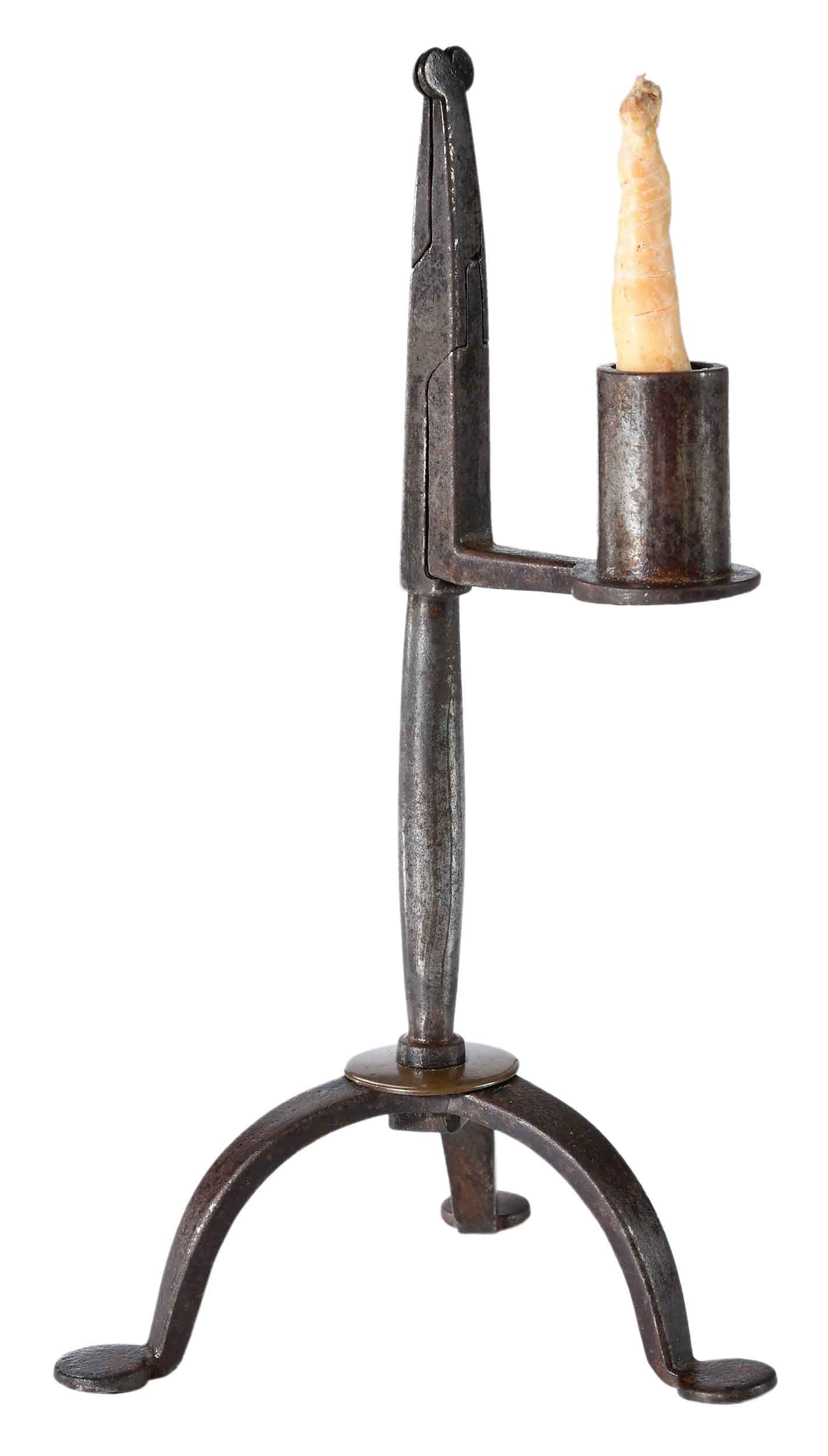 Fine Early Steel and Brass Heart Decorated Rush Nip and Candleholder: British, probably Wales, circa 1800, steel and possibly iron, heart decoration at top, brass disc at the tripod base, attractive and consistent patina to steel, old candle included, 8-1/2 x 4-1/4 x 4-