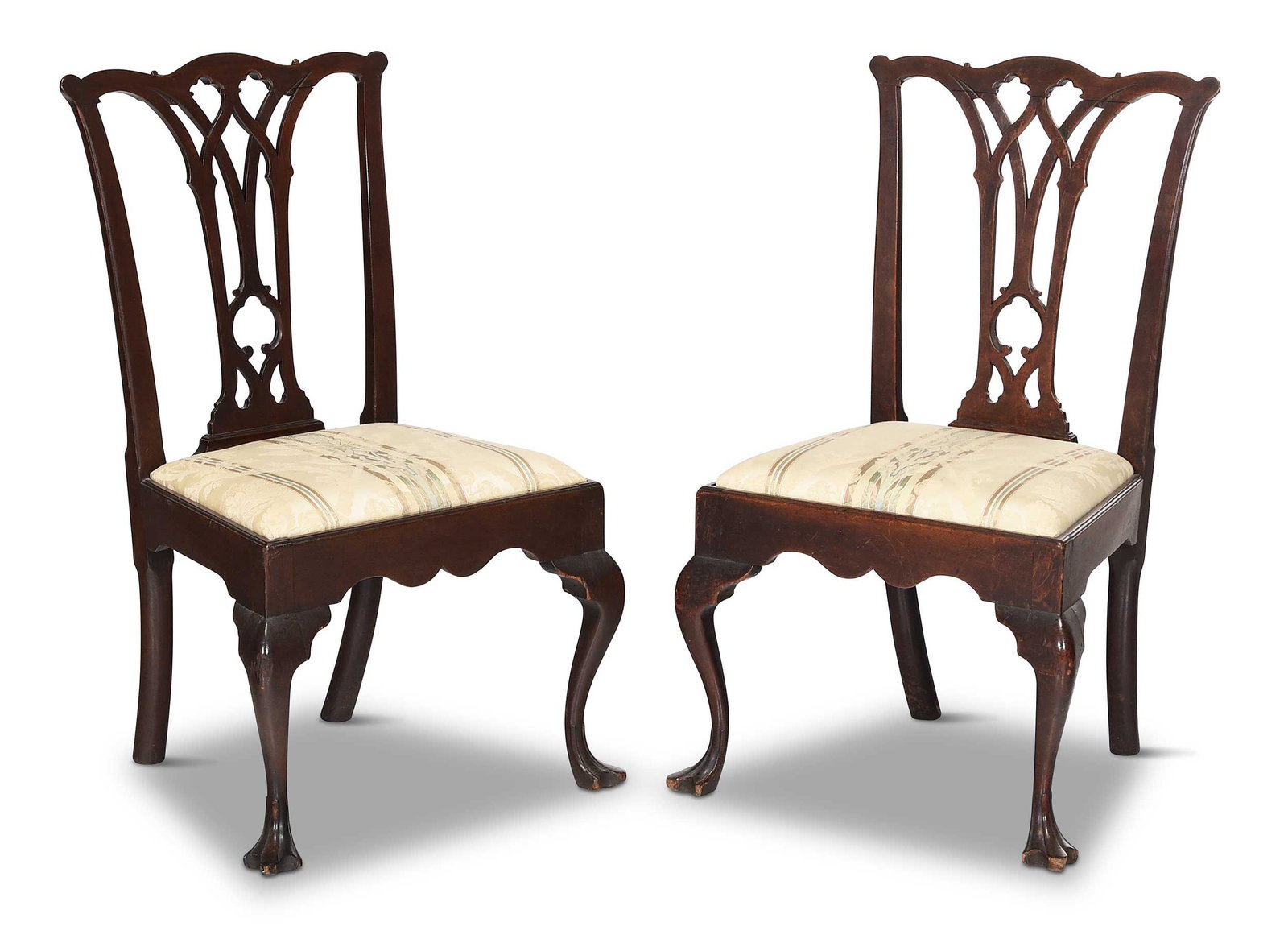 Pair of Philadelphia Chippendale Carved Mahogany Side Chairs in Old Surface: Pennsylvania, circa 1765, gothic pierced splats, trifid feet, period yellow pine slip seats with silk damask upholstery, one chair with "XII" to rear seat rail, the other with "II", 38-3/4 x 23-1/4 x 