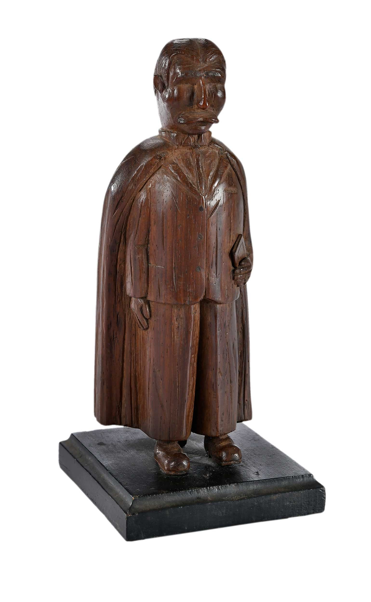 Initialed and Dated Sewanee, Tennessee Folk Art Carving of a Professor: Monteagle, Tennessee area, carved initials "CAP" at proper left lower cape, inscribed on base "Sewanee / MCMXXVIII [1928] / Prof.", carving 8-3/4 in., 9-1/4 x 4-1/8 x 4-5/8 in. including stand Provena