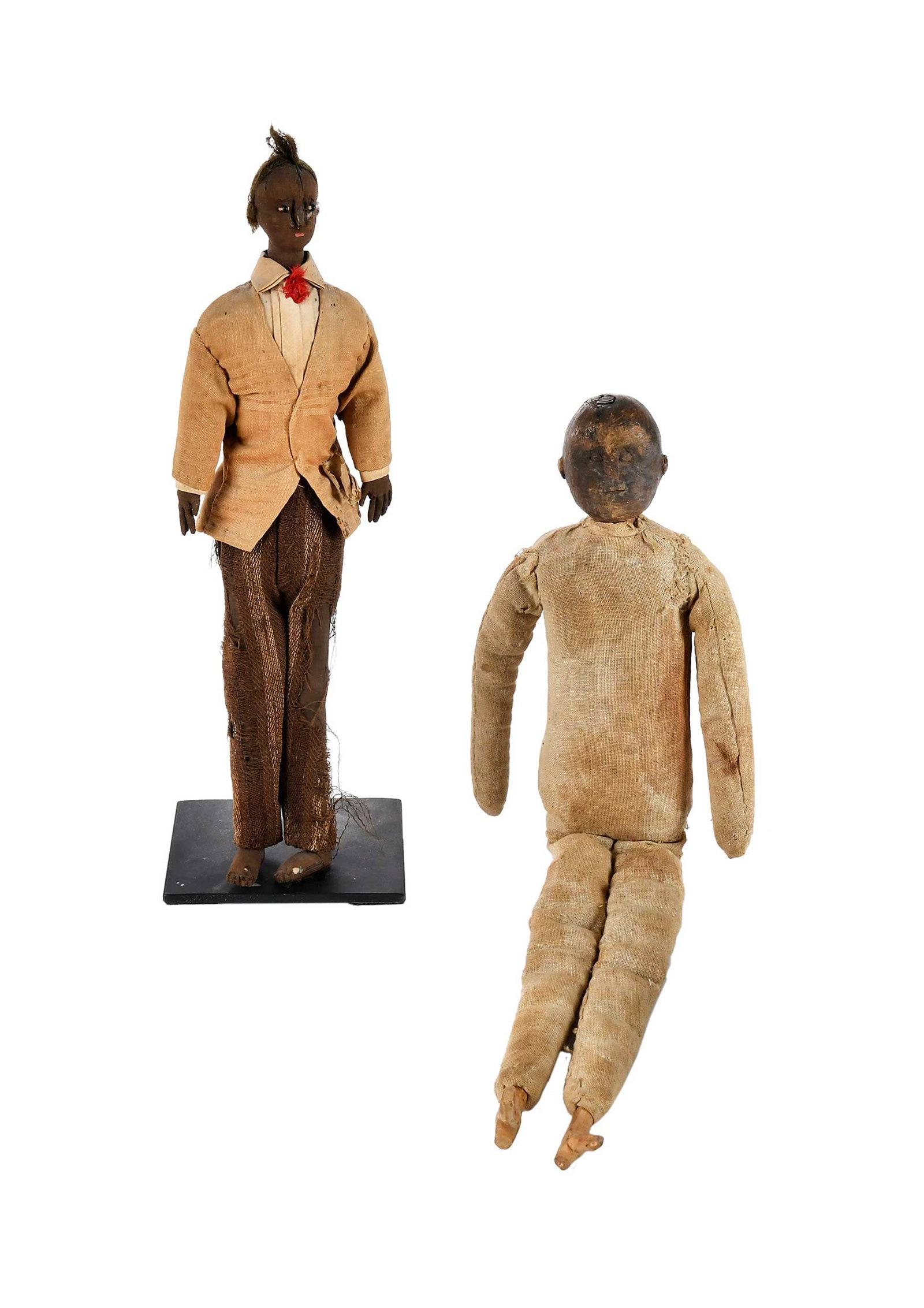 Two Black Americana Folk Art Dolls, Wheatcroft Provenance: 19th century, each of cloth and carved wood construction, one with metal stand, larger 16 x 6 x 2 in. Provenance: (standing example) According to consignor notes, acquired from David Wheatcroft; From 
