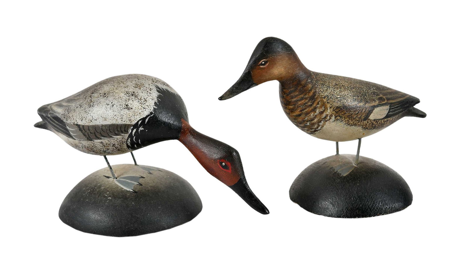 Elmer Crowell Pair of Miniature Canvasback Decoys: East Harwich, Massachusetts, circa 1940s, possible matched pair, standing hen and unusual feeding drake, maker's rectangular stamp at base, collector's labels at base, drake: 2-1/2 x 4-3/4 x 2-1/2 in.