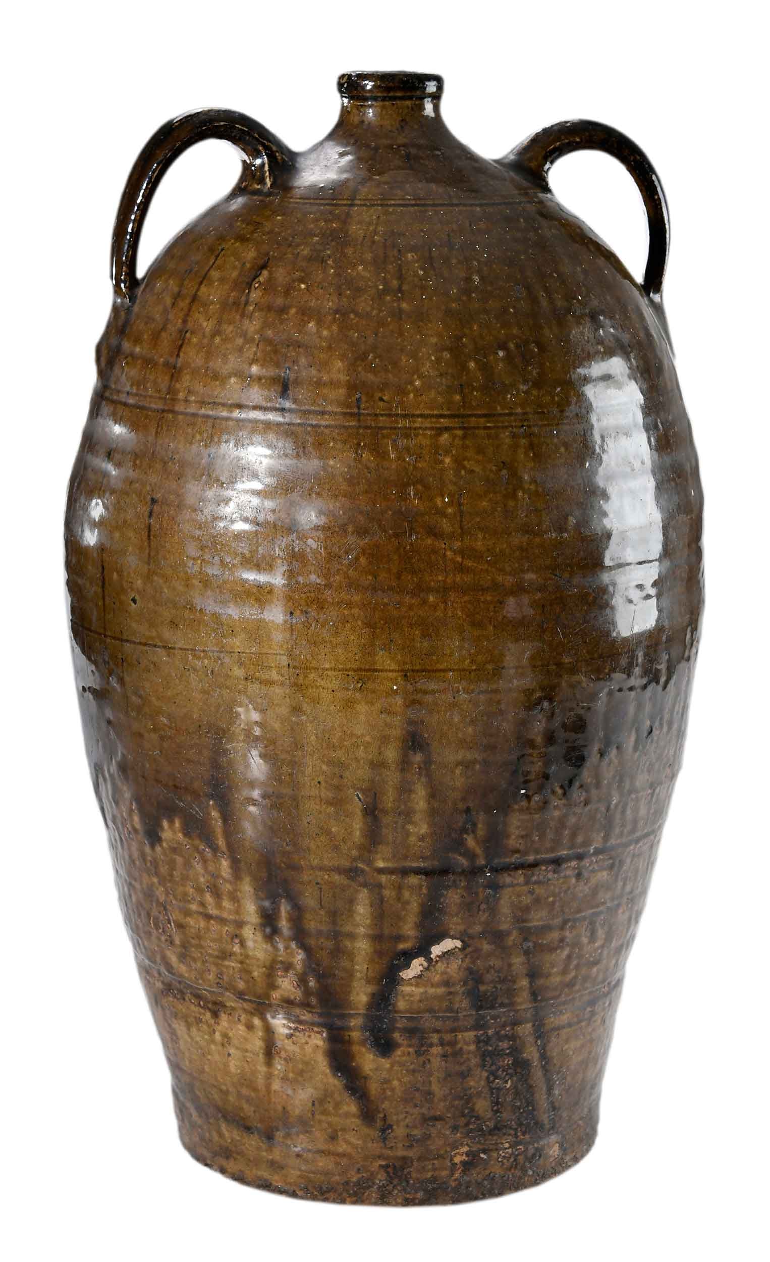 Monumental Alabama Attributed Two Handle Stoneware Jug: possibly Randolph County, or Sand Mountain, circa late 1800s, thick runny dark green alkaline glaze with black streaks over mottled runny light olive green alkaline glaze, elongated ovoid form with