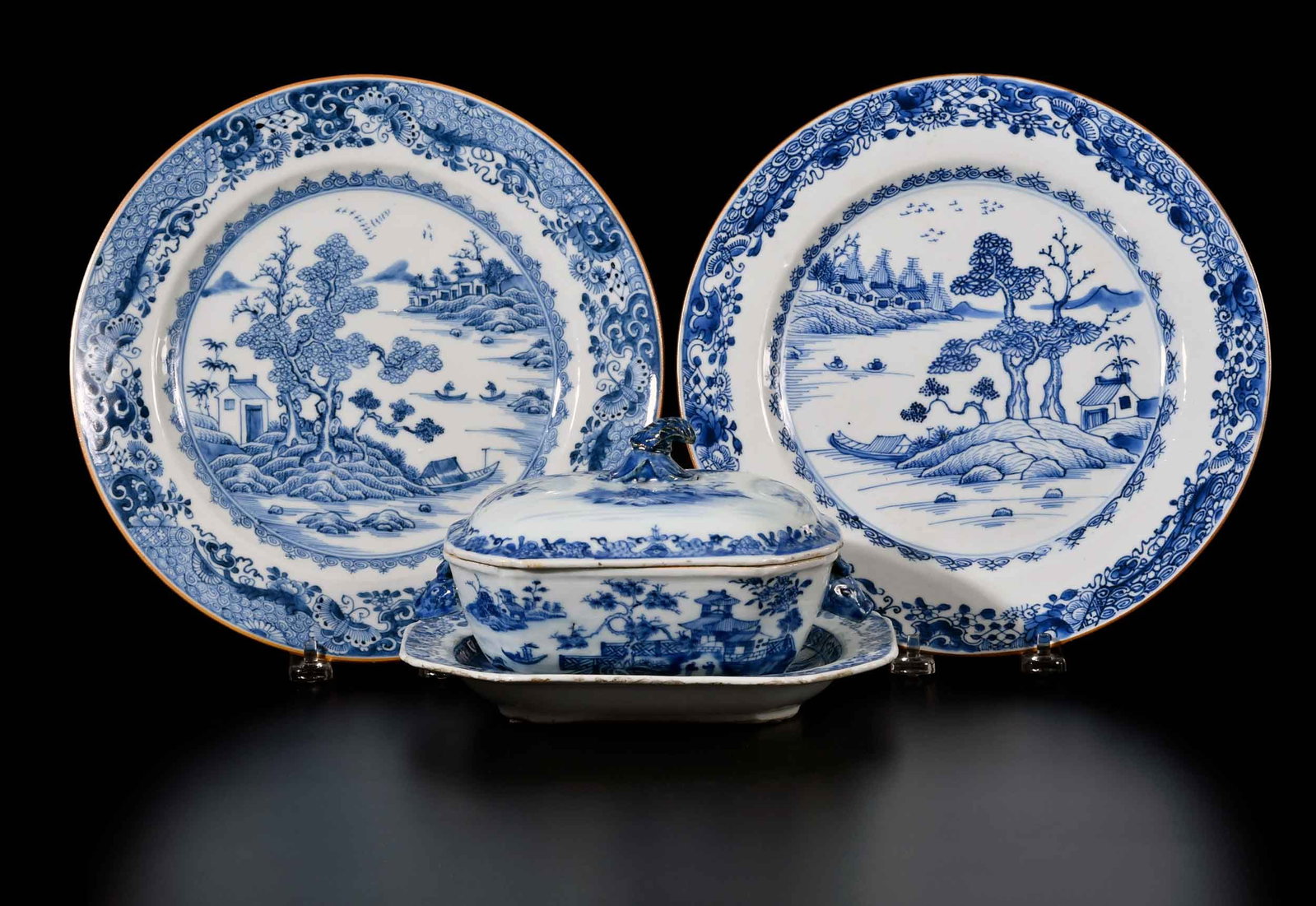 Four Pieces of Chinese Export Blue and White Porcelain: 18th/19th century, diapered borders with rural lake scenes, comprising: two similar dinner plates; small lidded tureen with underplate; largest 1-1/4 x 10-1/4 x 10-1/4 in. Provenance: Collection of