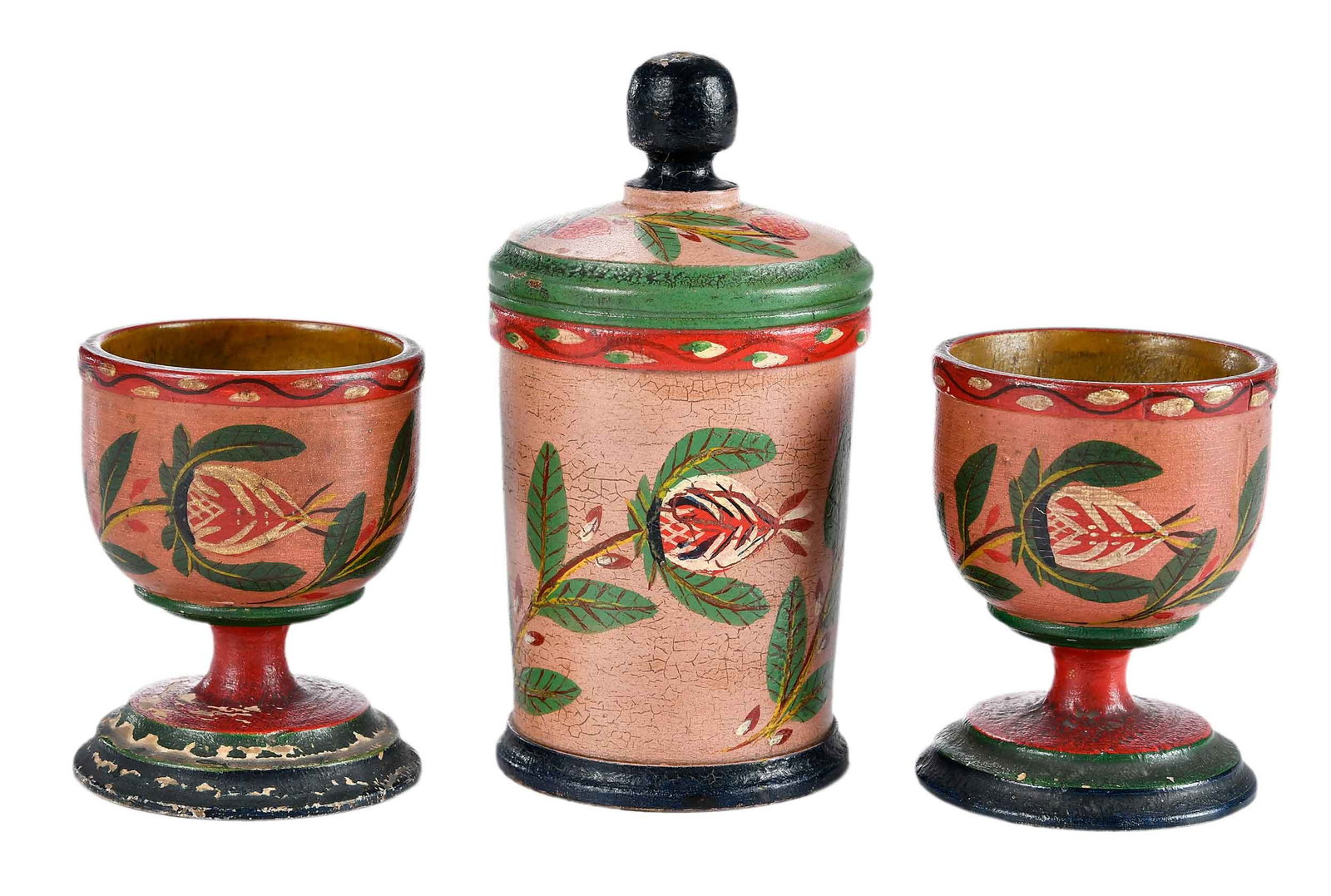 Group of Three Lehnware Polychromed Table Objects: Lancaster, Pennsylvania, 19th century, turned and polychrome painted poplar, comprising: pair of egg cups or salts with pomegranate motif; lidded saffron jar with pomegranate and strawberry motif; lar