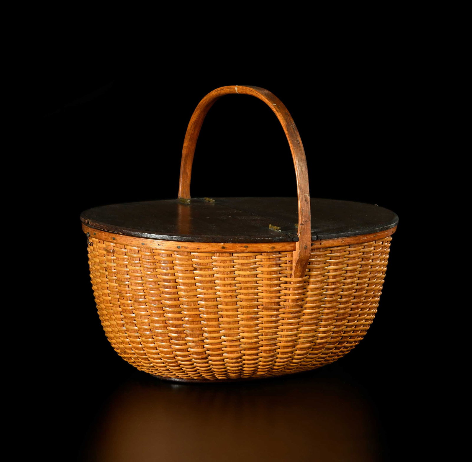 Large Double Lidded Nantucket Lightship Basket: Massachusetts, 19th century, hickory ribs and handle, mahogany lids, partial label to underside of base reads "Ma--/Willia----dwin Hosier/Nantucket/Sold me by Mrs. Brown of/the Quaker Antique shop.", 