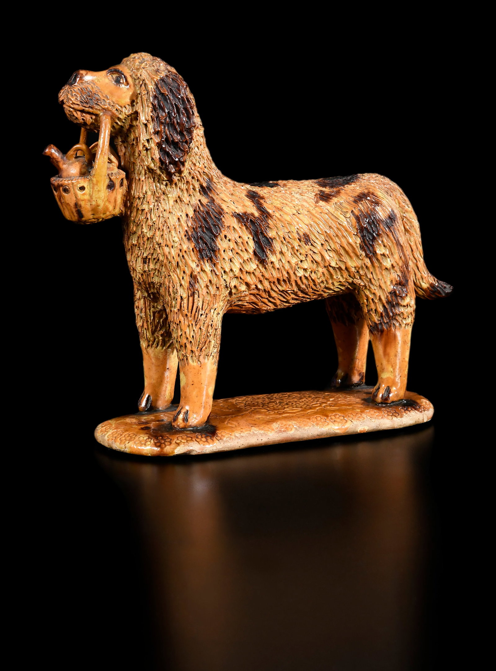 Extremely Rare and Important John Bell Waynesboro, Pennsylvania Attributed Earthenware Dog with: attributed to the John Bell Pottery, circa 1860-1890, lead oxide, manganese and engobe glaze, figural dog form with highly incised upper body and head, articulated fur, sculpted snout and nose, incise