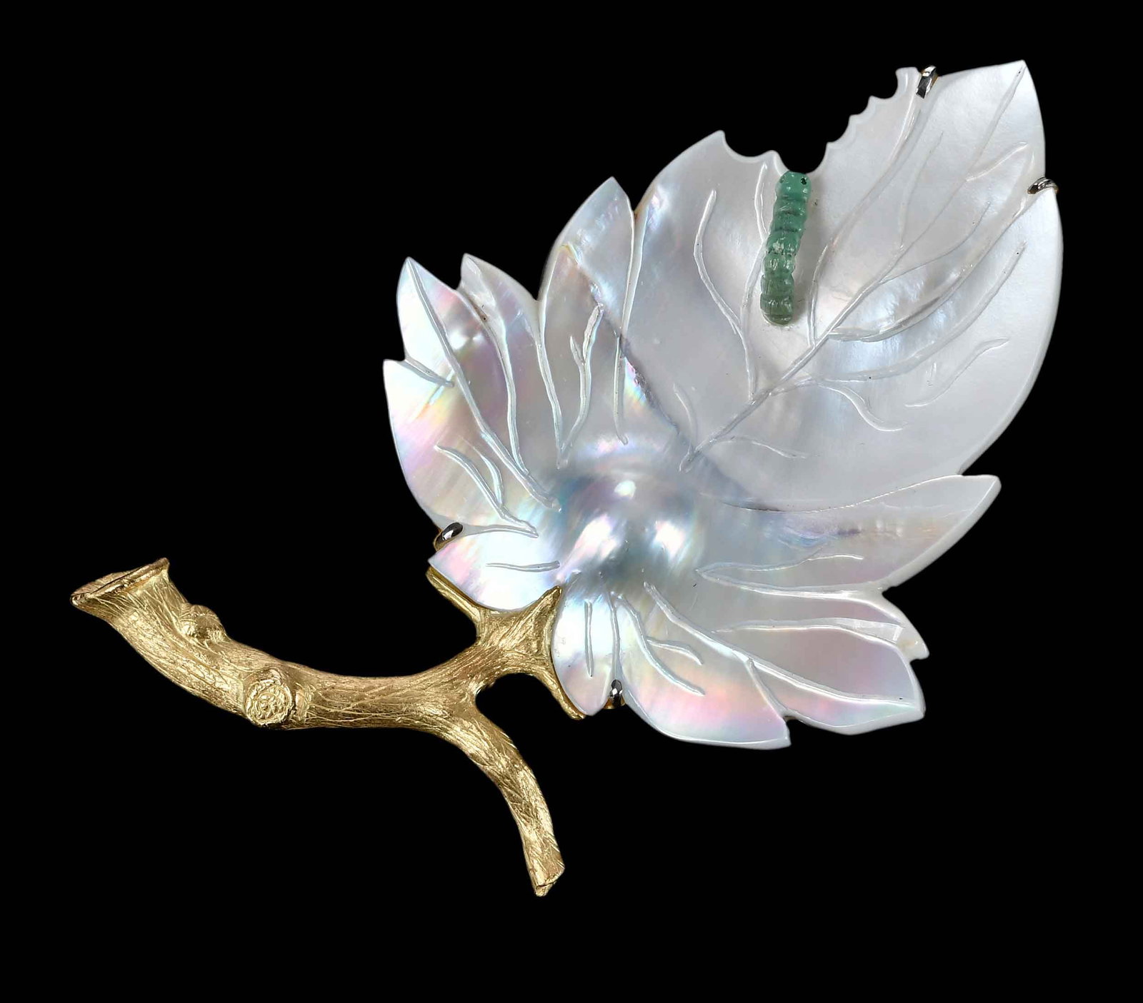 18kt. Mother of Pearl Leaf Form Brooch: textured branch, possibly jade inch worm, marked "18k", yellow gold, maker's mark, 3-1/2 x 2 in. overall design, 31.7 g Provenance: Collection of Dr. George and Connie Manger Note: Brunk Auctions
