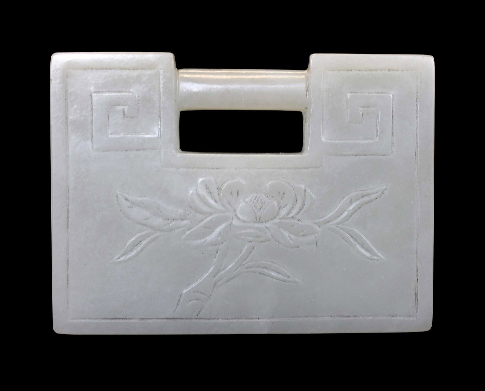 Chinese Carved Jade Lock Form Pendant: carved of pale green jade with small white and black inclusions, 2-3/8 x 3-1/4 x 1/4 in. Provenance: The Collection of William S. Arnett, Atlanta, Georgia; sold to benefit Tinwood Foundation Note: Thi