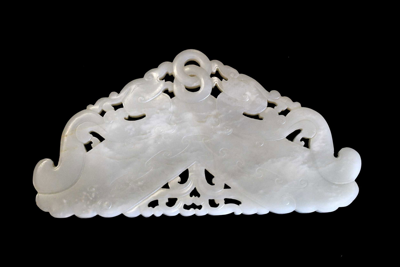 Chinese Carved Jade Auspicious Symbol Plaque: in the form of two dragons over chime stone in pale green jade with russet and white inclusions, 3-3/4 x 8-1/8 x 1/4 in. Provenance: The Collection of William S. Arnett, Atlanta, Georgia; sold to bene