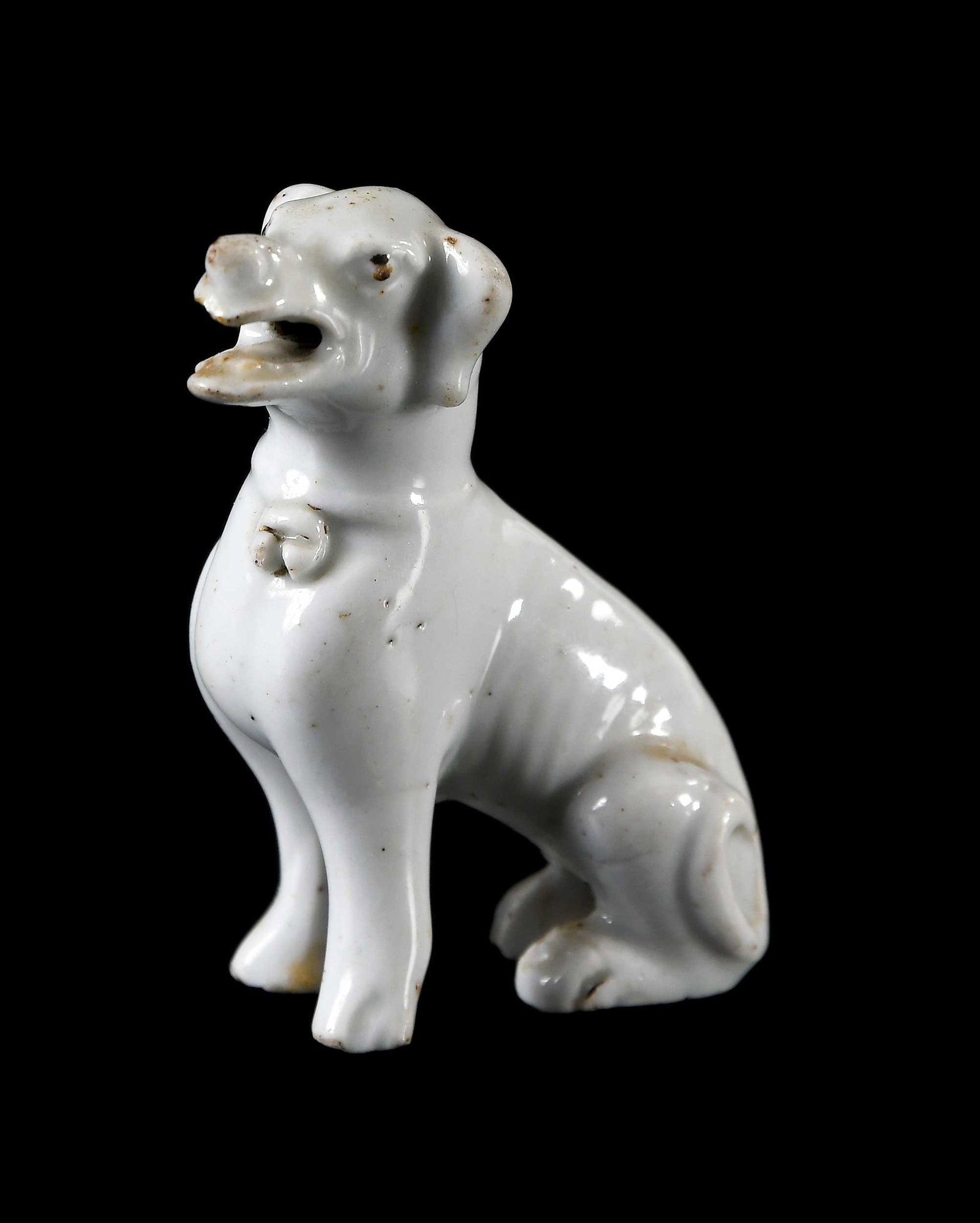 Chinese Blanc de Chine Seated Dog: Qing dynasty, 3 x 3 x 1-1/8 in. Provenance: The Collection of William S. Arnett, Atlanta, Georgia; sold to benefit Tinwood Foundation