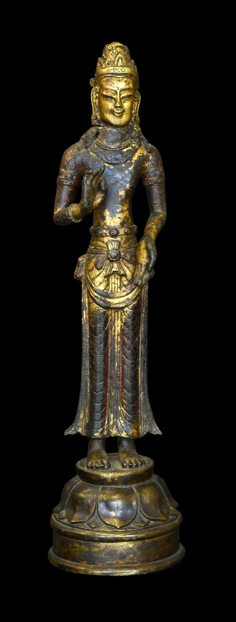 Southern Chinese Gilt Bronze Standing Bodhisattva Figure: Yunnan Province, Dali Kingdom or style, depicting a bodhisattva, probably Avalokiteshvara, with hands raised in vitarka mudra standing atop a lotus base, 17 x 4-1/2 x 4-1/2 in. Provenance: The