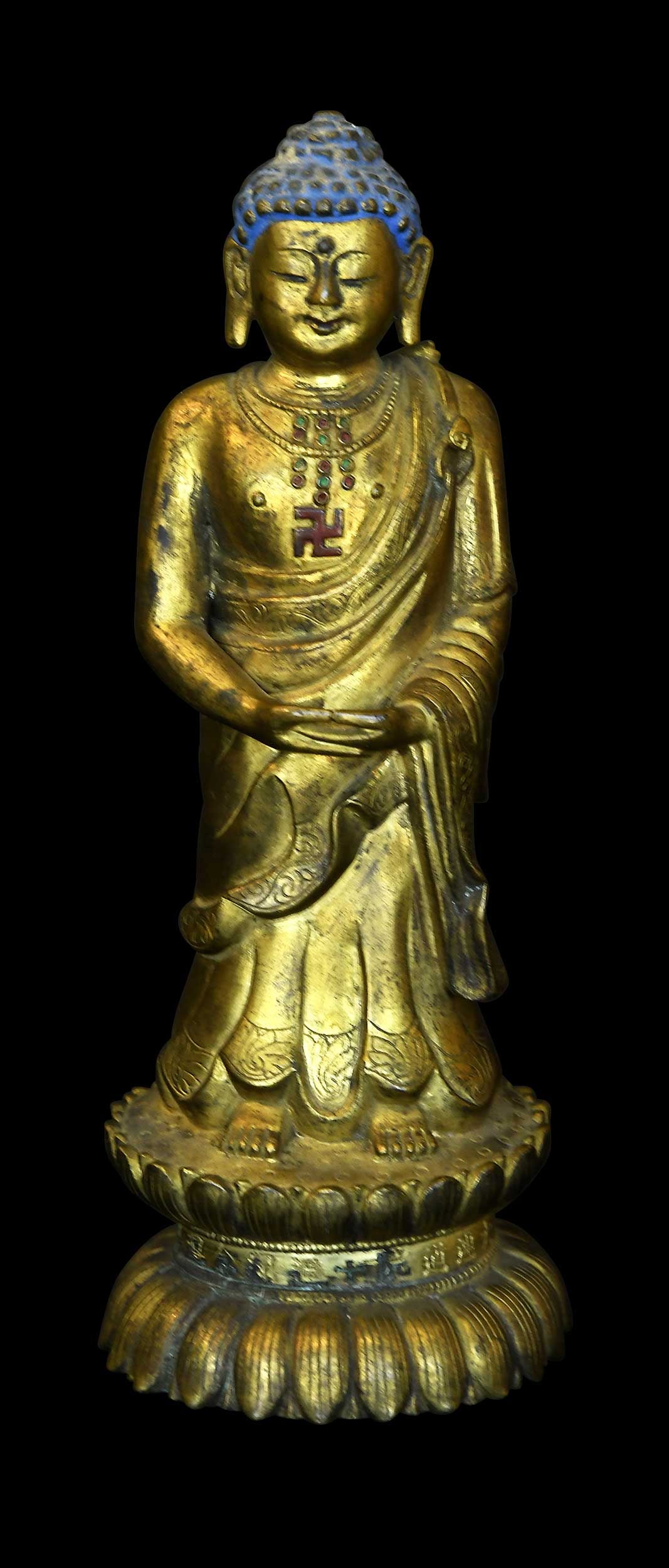 Chinese Gilt Bronze Standing Buddha Figure: Qing dynasty, robed buddha with sauvastika on chest standing with hands in dhyana mudra atop lotus base, inscription in Chinese around base, 8-1/2 x 3-1/8 x 3-1/8 in. Provenance: The Collection of Wil