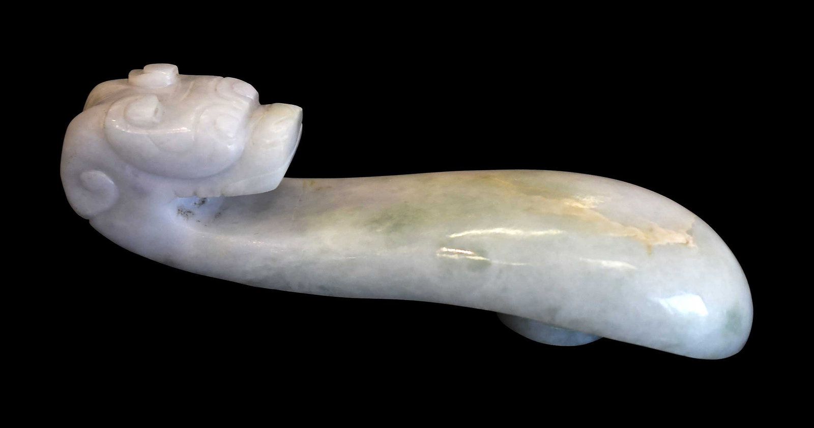 Chinese Carved Jade Horned Dragon Belt Hook: qiulong (horned dragon) head motif in mottled white jade with green and cream inclusions, 4-7/8 x 1-1/4 x 1-3/8 in. Provenance: The Collection of William S. Arnett, Atlanta, Georgia; sold to benefit T