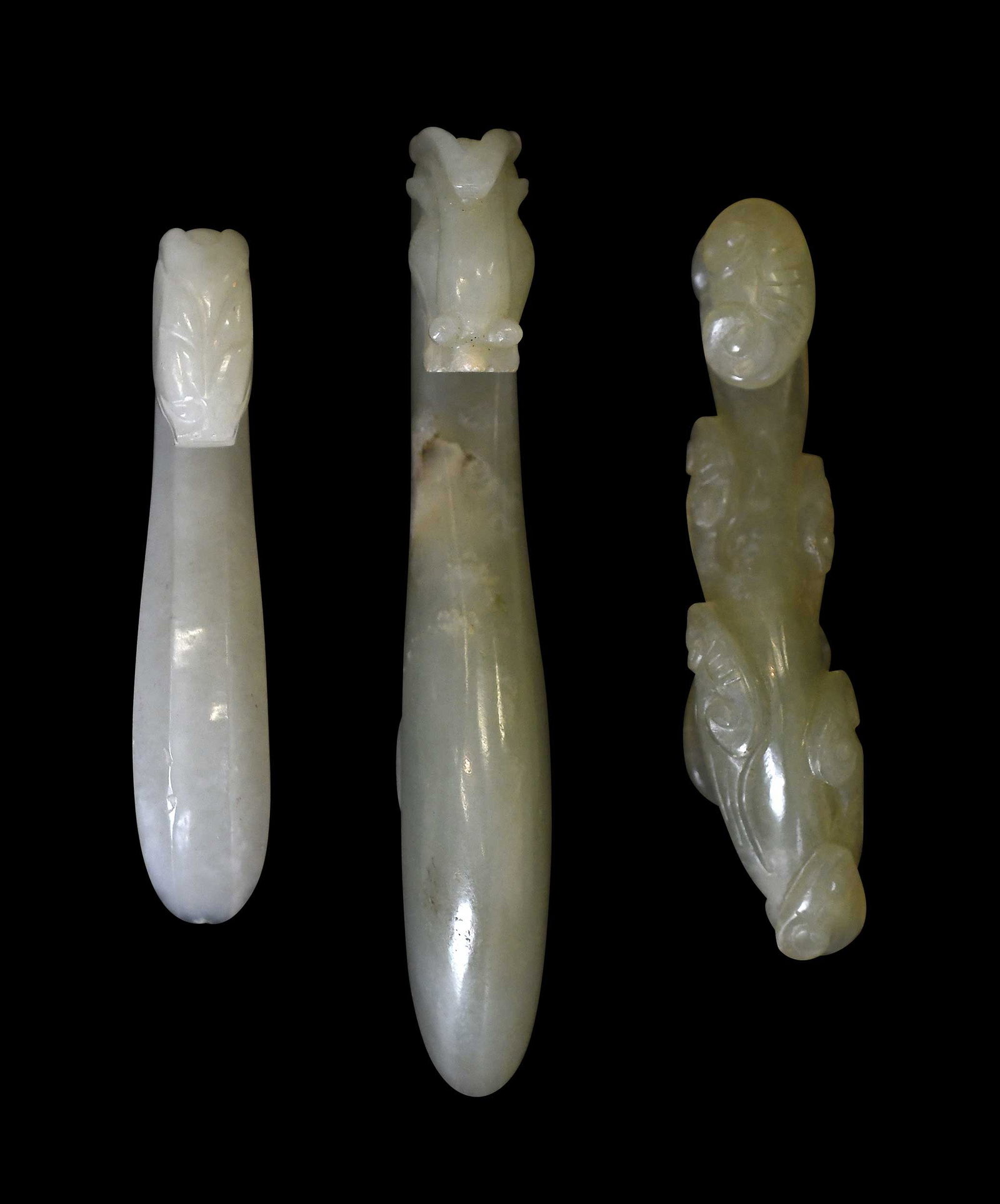 Three Small Chinese Carved Jade Belt Hooks: each pale green, two with carved dragon/chilong heads, one with carved lingzhi, largest 3-3/4 x 5/8 x 1 in. Provenance: The Collection of William S. Arnett, Atlanta, Georgia; sold to benefit Tinwood F