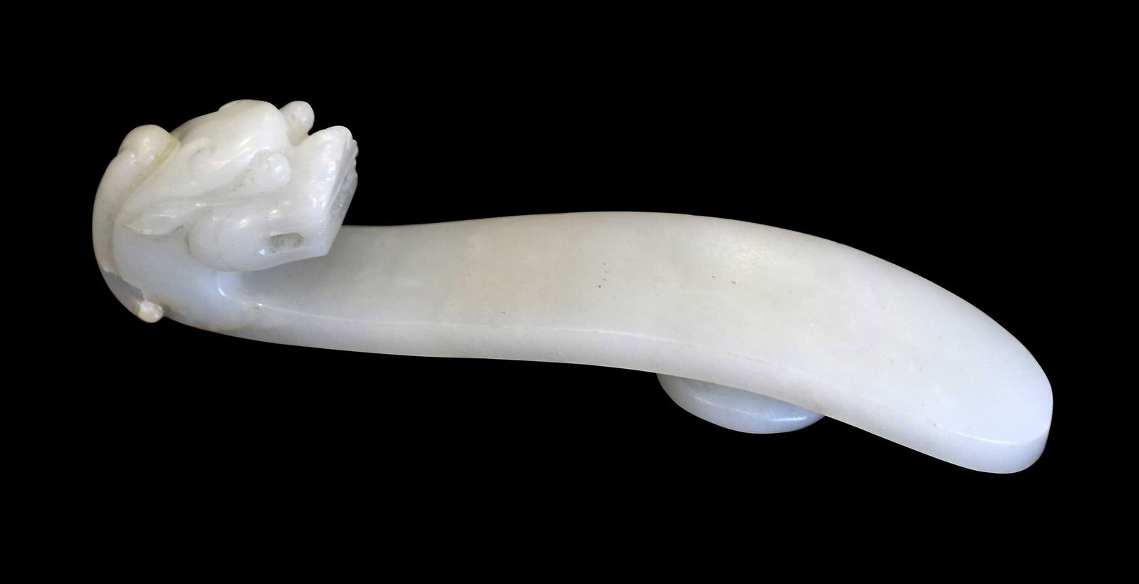 Chinese Carved Jade Belt Hook: qiulong (horned dragon) head motif in pale celadon jade with small russet inclusions, 4-1/2 x 1 x 1-1/8 in. Provenance: The Collection of William S. Arnett, Atlanta, Georgia; sold to benefit Tinwood F