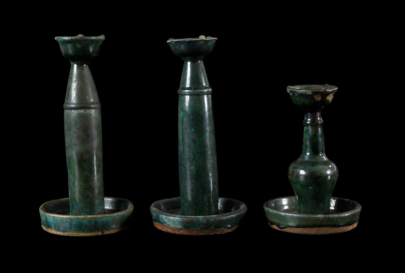 Three Chinese Green Glazed Pottery Oil Lamps: possibly late Ming dynasty, each in mottled green glaze, largest 11-1/8 x 5-1/4 x 5-1/4 in. Provenance: The Collection of William S. Arnett, Atlanta, Georgia; sold to benefit Tinwood Foundation