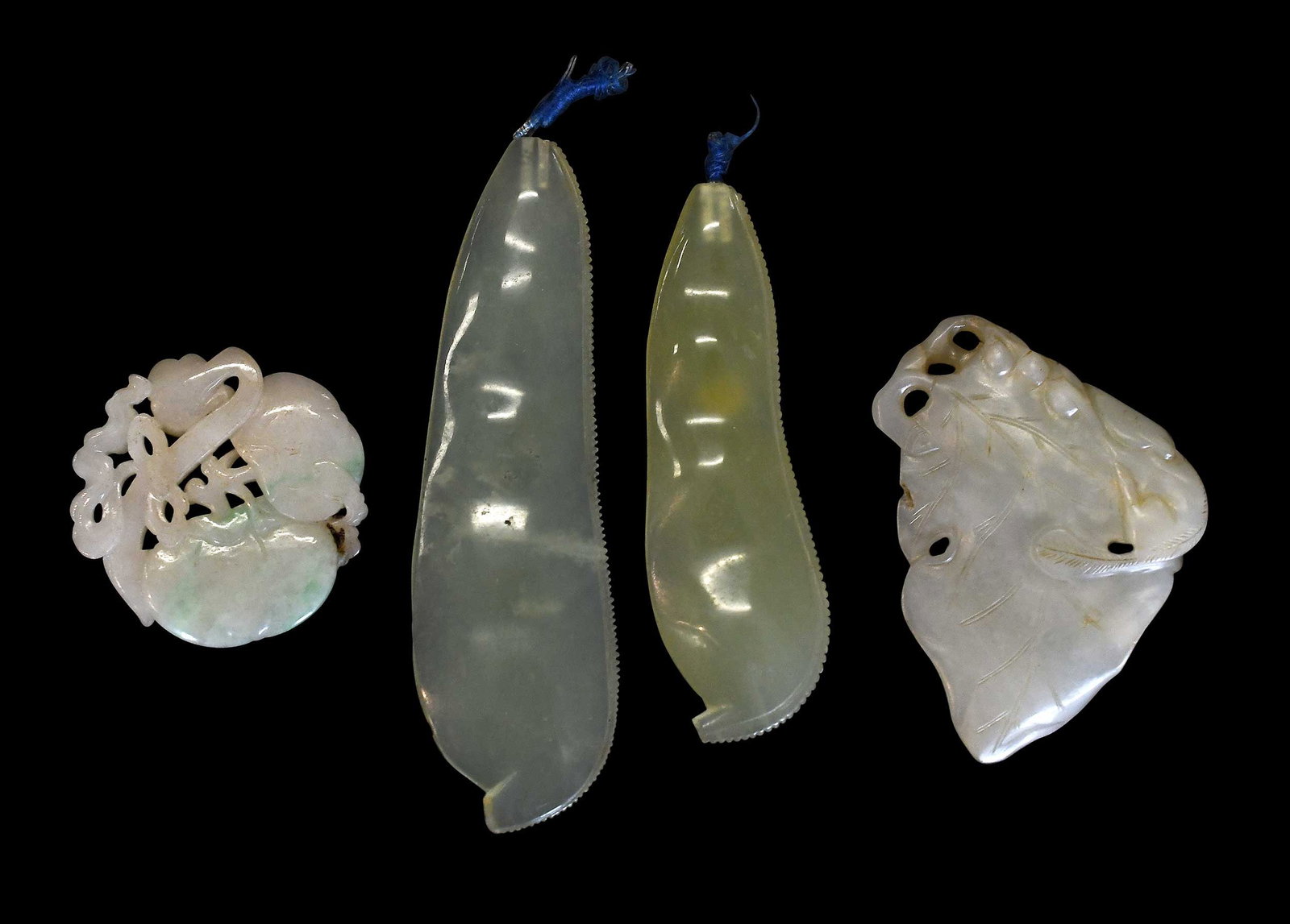 Four Chinese Carved Jade Objects: comprising: two pea pods; persimmons; leaf with mouse; largest 5-1/2 x 1-3/8 x 3/8 in. Provenance: The Collection of William S. Arnett, Atlanta, Georgia; sold to benefit Tinwood Foundation Note: