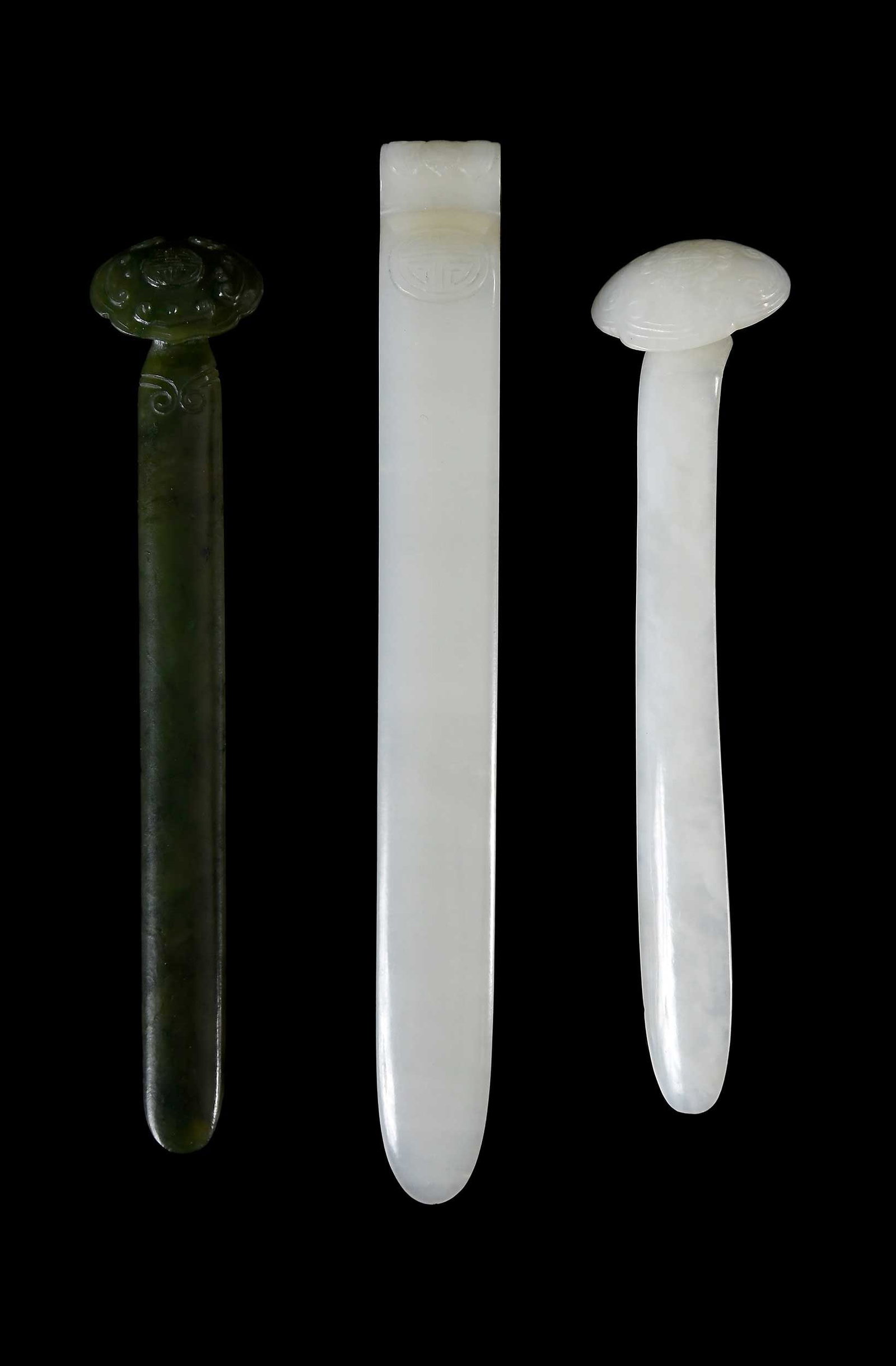 Three Chinese Carved Jade Hairpins: two of pale celadon jade and one of spinach green jade, largest 6-7/8 x 3/4 x 5/8 in. Provenance: The Collection of William S. Arnett, Atlanta, Georgia; sold to benefit Tinwood Foundation Note: These