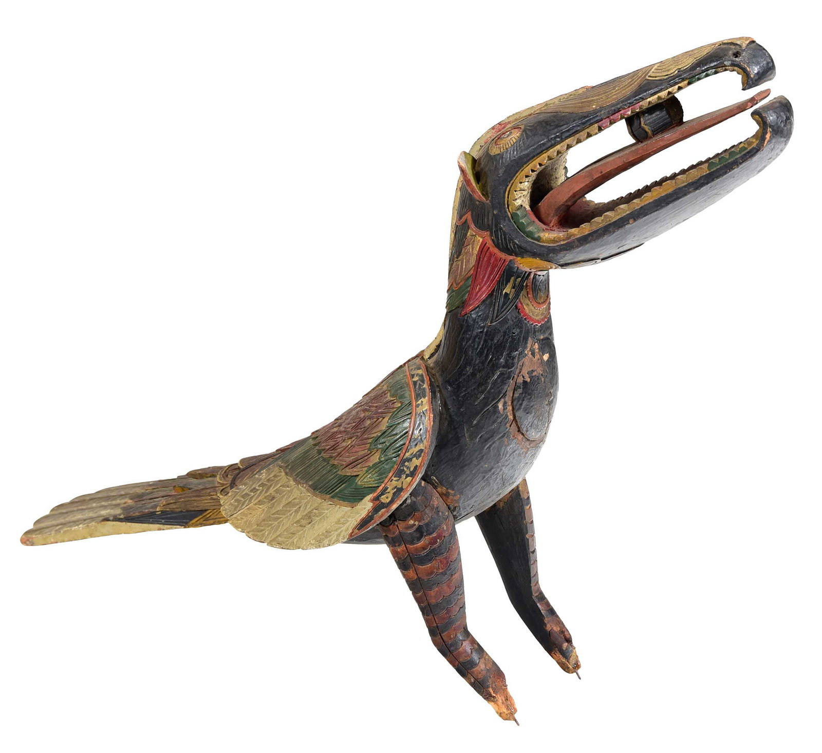 Southeast Asian Carved and Paint Decorated Wood Bird Sculpture: first half 20th century, stylized bird with gilt and polychrome paint, long beak with teeth, small object on tongue, in current state 18-1/2 x 21 x 5-3/4 in. Provenance: The Collection of William S.