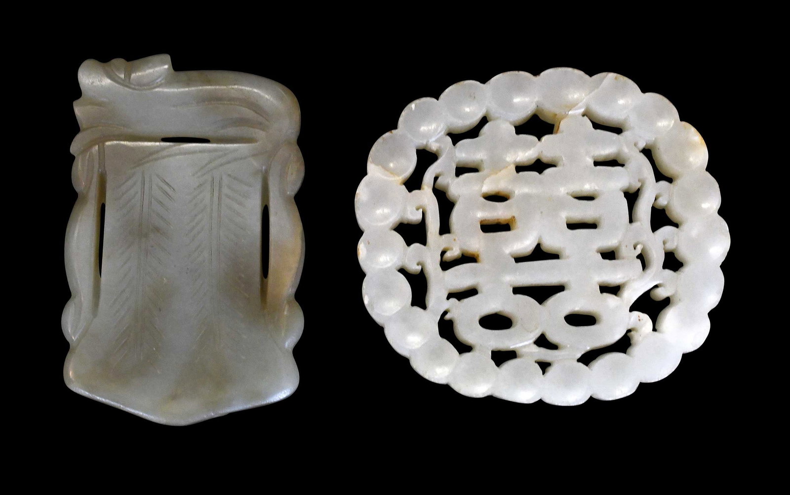Two Chinese Carved Pale Green Jade Plaques: one with openwork double happiness symbol, larger 2-1/4 x 2-1/2 x 1-1/4 in. Provenance: The Collection of William S. Arnett, Atlanta, Georgia; sold to benefit Tinwood Foundation Note: These items test