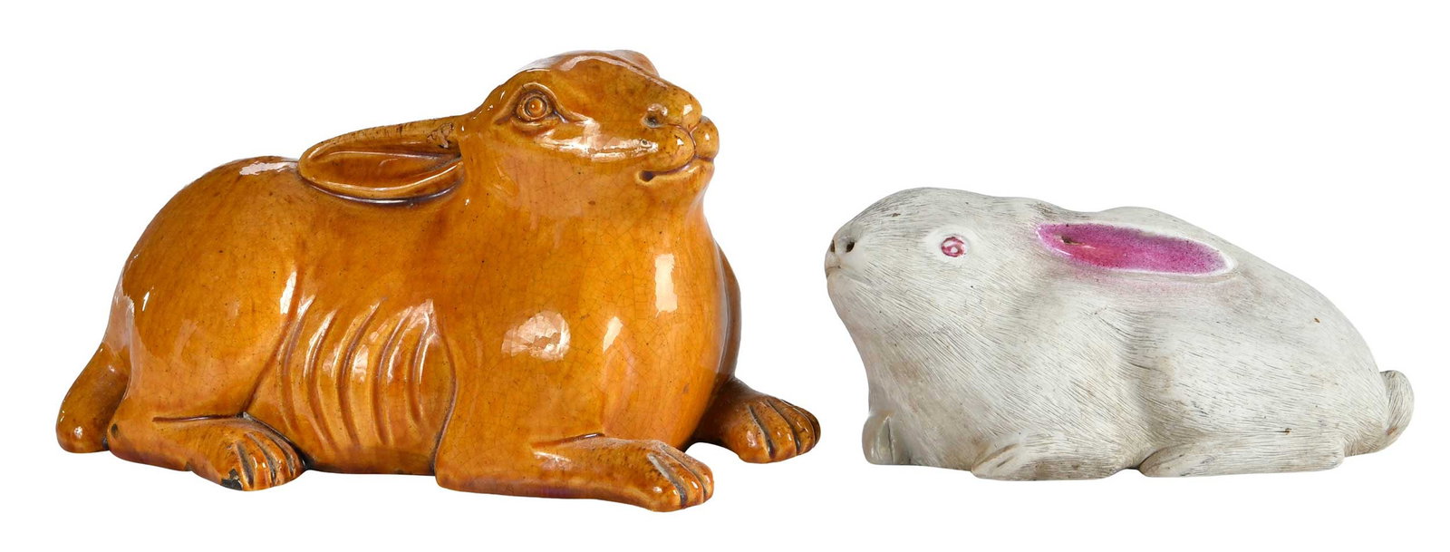 Two Chinese Export Rabbits: brown glazed rabbit, resting with ears laid back; white bisque with ears laid back, pink glaze, incised fur, label reads "James Galley, Chinese Export, Porcelain, Circa 1830", 4 x 7-3/4 x 3-1/2 in.