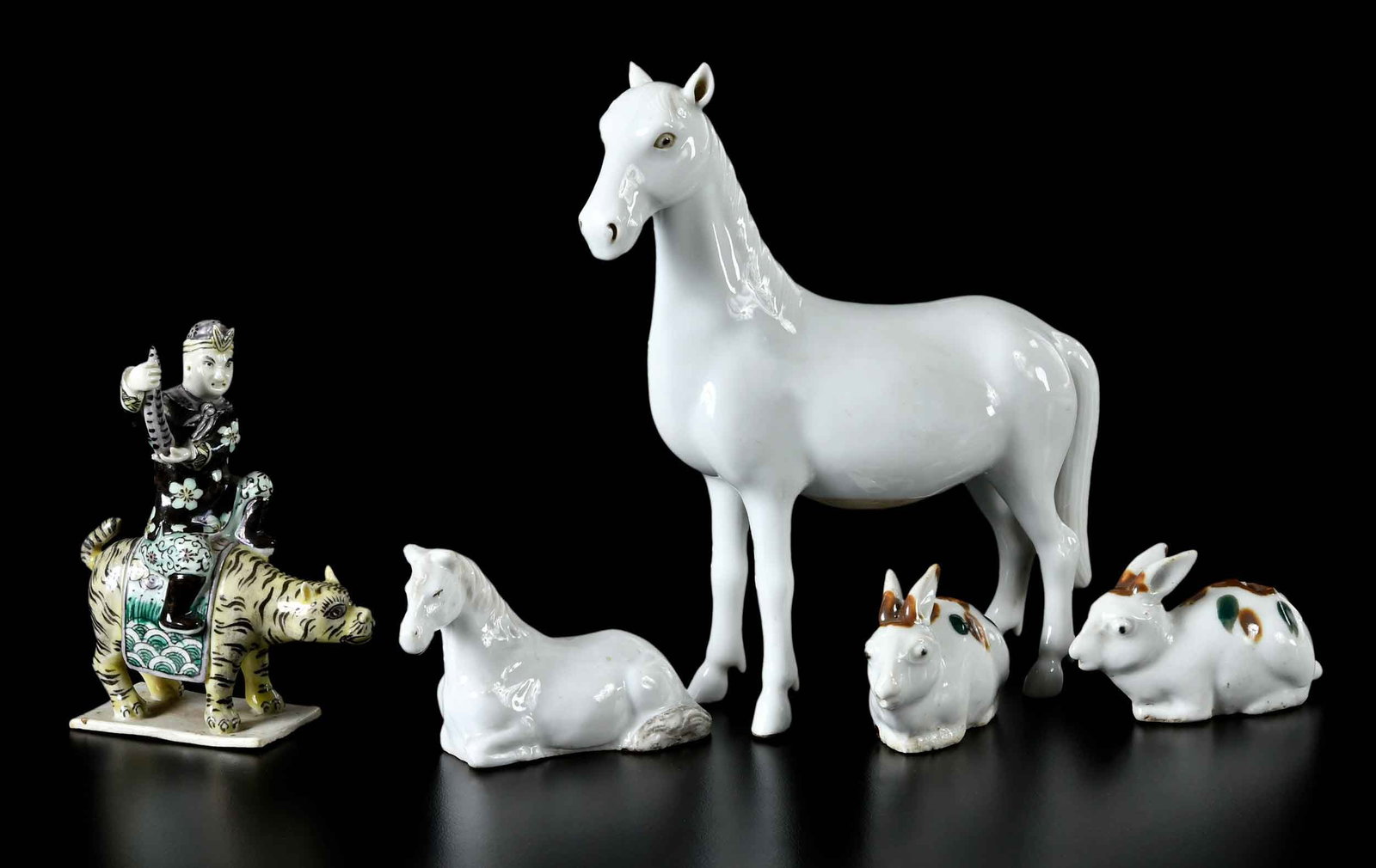 Five Chinese Export Animal Figures: polychrome decorated man riding yellow tiger; pair of rabbit form water droppers; recumbent horse; standing horse, 7 x 6 x 2-1/2 in. Provenance: The Collection of Joe Matthews and John Shank,