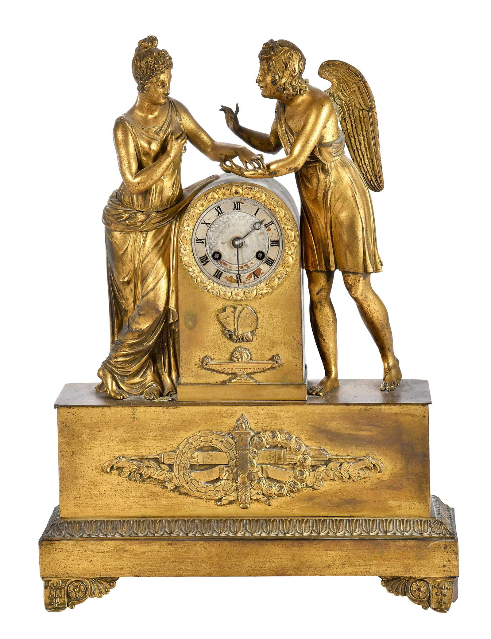 French Empire or Style Gilt Bronze Figural Mantel Clock: 19th century, metal dial with Roman numerals set in gilt bronze case with figures of Eros and Psyche, ribbon swag appliques, removable panel verso opening to works, 18 x 13 x 4 in. Provenance: The Col