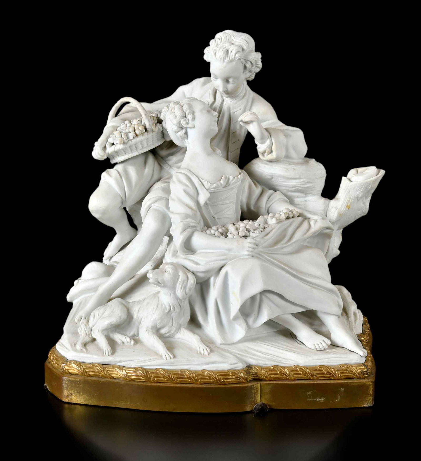 Sevres Style Large Bisque Porcelain Group, The Grape Eaters: French, late 18th century/early 19th century, incised Sevres style mark to underside of porcelain base visible through cut out in later brass base, 9-3/4 x 9-1/2 x 10 in. Provenance: The Collection of