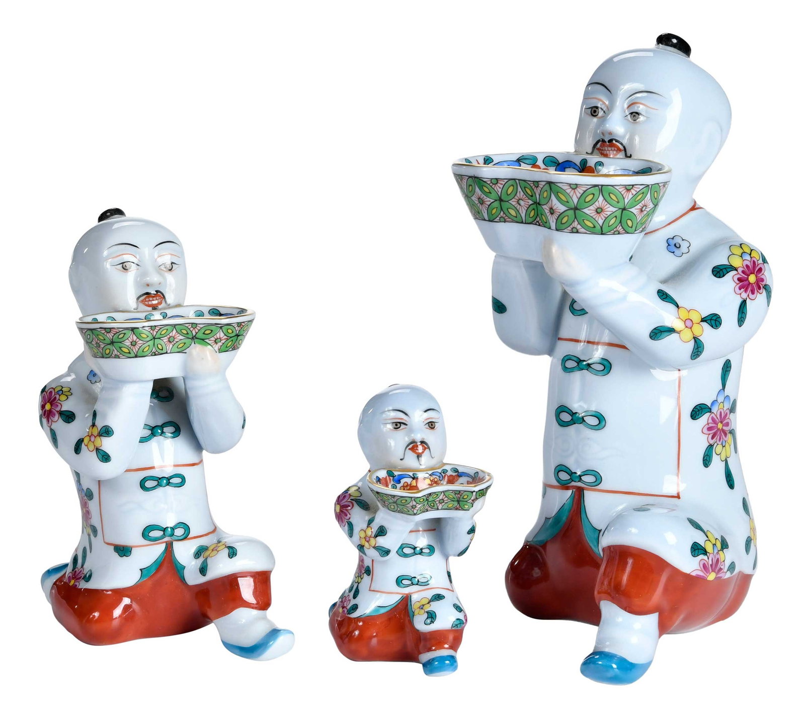 Three Herend Porcelain Graduated Attendant Figures: 20th century, Herend marks to bases, largest 6-1/2 x 2-1/2 x 5 in. Provenance: The Collection of Joe Matthews and John Shank, Shepherdstown, West Virginia