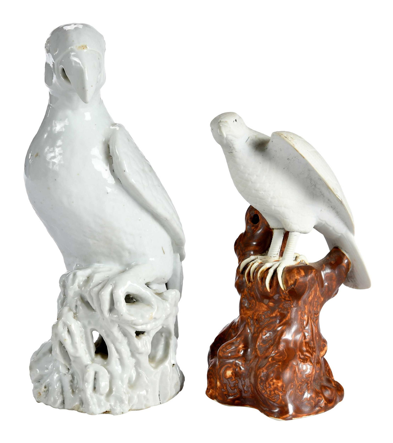 Two Asian Porcelain Bird Figural Table Objects: probably 19th century, unmarked, comprising: Chinese blanc de chine parrot on a stump; Japanese hawk on a stump; larger 10 x 4-1/4 x 5-3/8 in. Provenance: The Collection of Joe Matthews and John