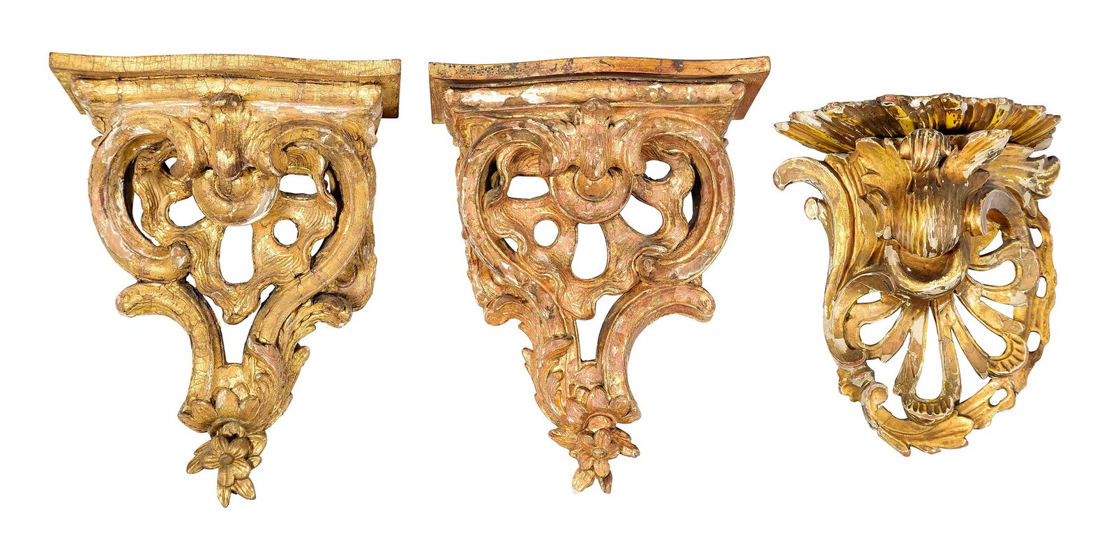 Three Continental Carved and Gilt Wood Wall Brackets, Two Additional: comprising 19th century pair and one single, largest 12-3/8 x 10 x 6-1/8 in.; 21st century pair with shaped tops and foliate carvings, 16 x 13 x 4-3/4 in. Provenance: The Collection of Joe Matthews