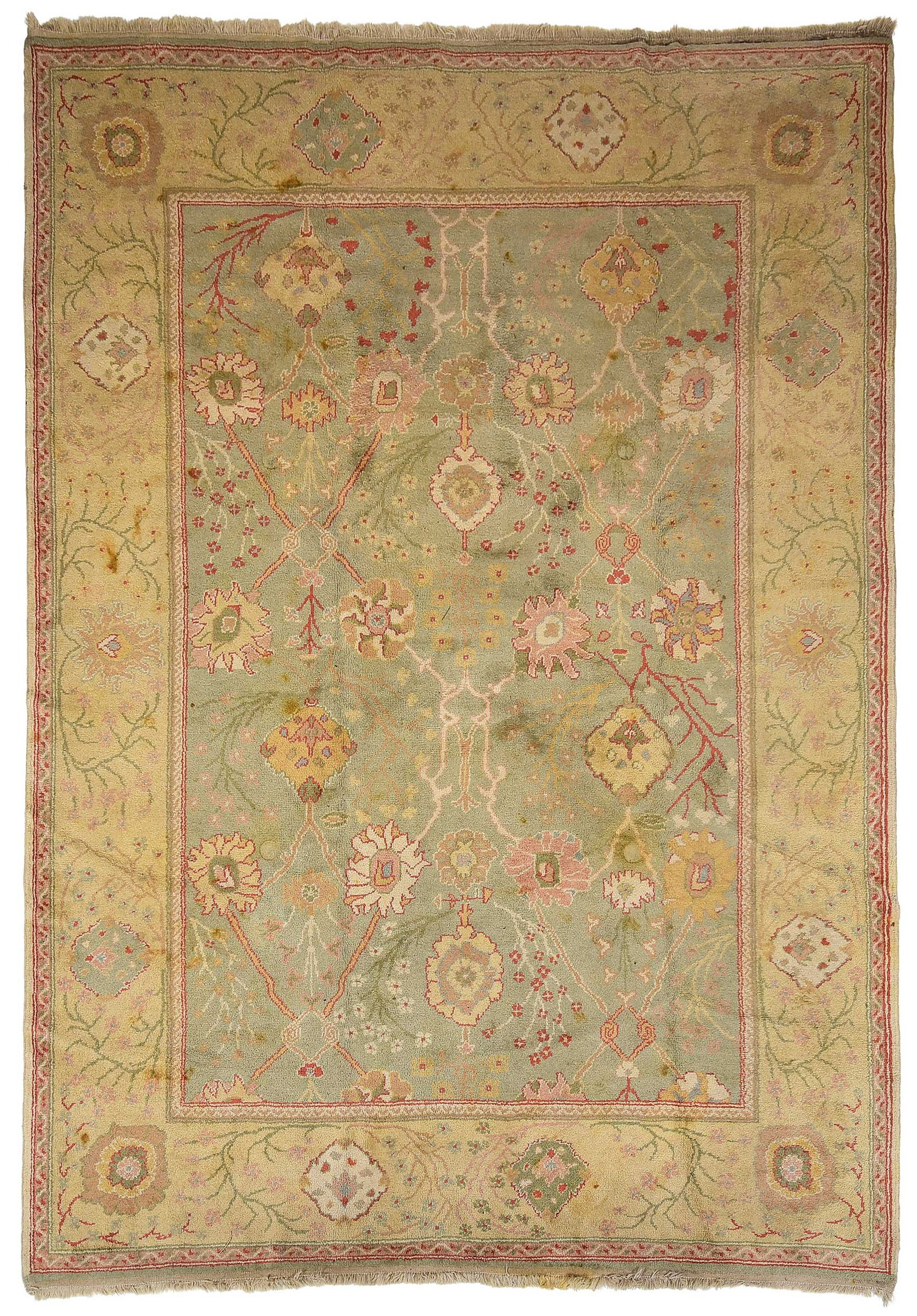 Turkish Carpet: 20th century, green field with oversized floral decoration, tan borders, 12 ft. 5 in. x 9 ft. 1 in. Provenance: The Collection of Joe Matthews and John Shank, Shepherdstown, West Virginia
