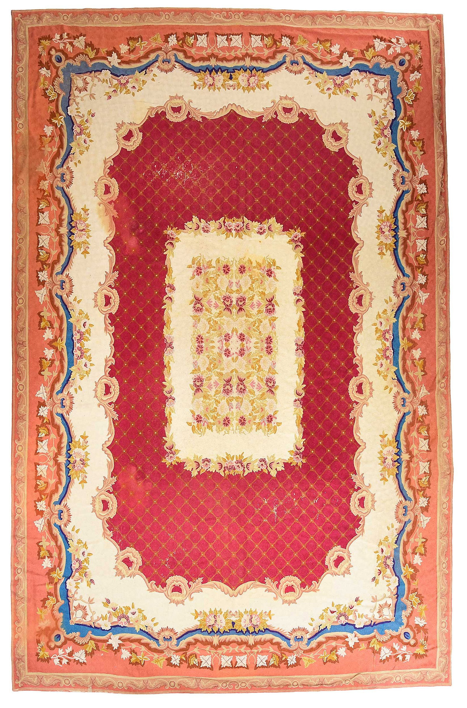 Needlework Carpet: 20th century, rectangular central medallion with florals, red field, white and salmon borders, 13 ft. 8 in. x 9 ft. 7 in. Provenance: The Collection of Joe Matthews and John Shank, Shepherdstown,