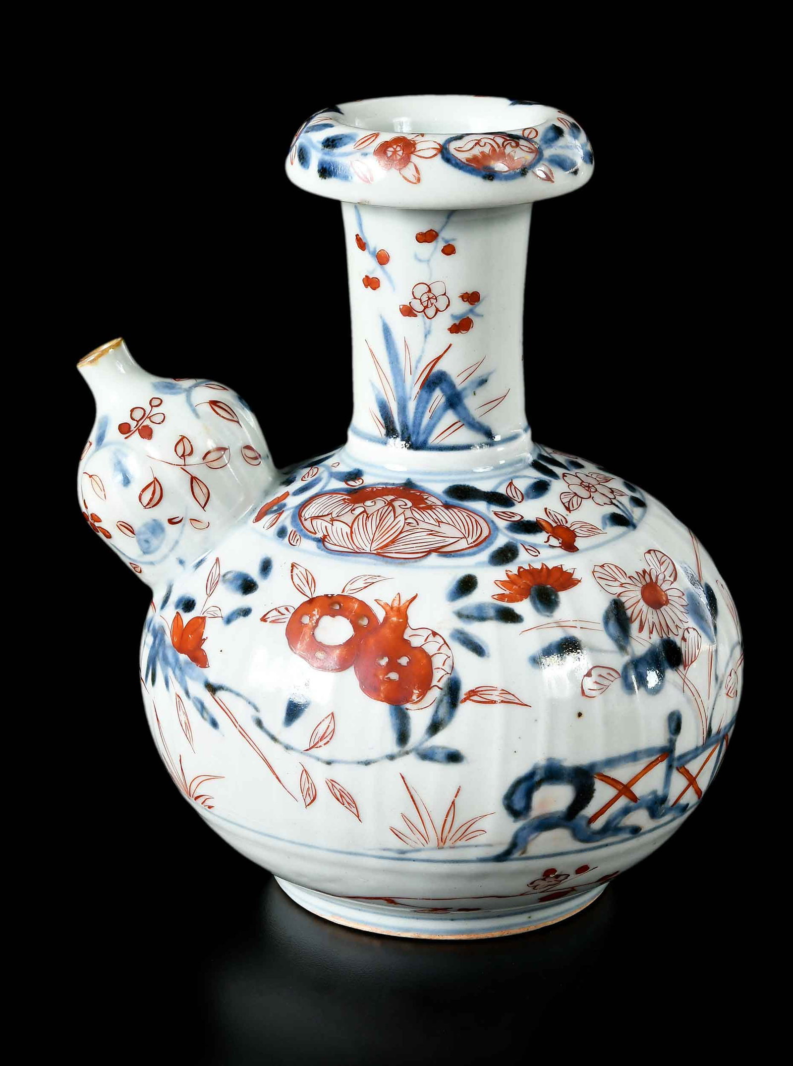 Japanese Export Imari Porcelain Kendi: possibly Meiji, blue underglazed and red overglazed, body with subtle ribbing, 8-1/4 x 7 x 6 in. Provenance: The Collection of Joe Matthews and John Shank, Shepherdstown, West Virginia