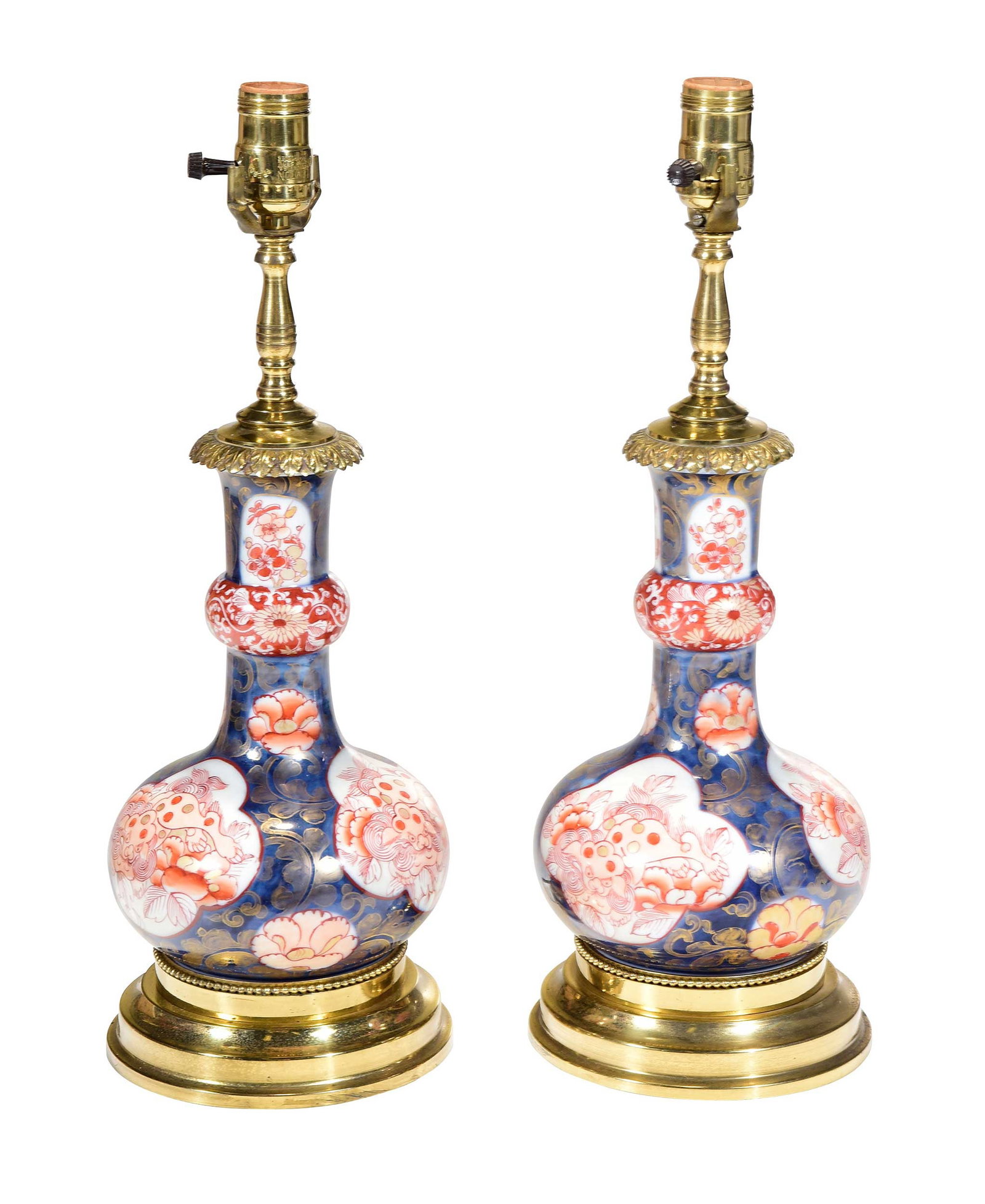 Pair of Chinese Imari Porcelain Vasiform Lamps: 20th century, blue and red imari with gilt detail, gold tone hardware and bases, nephrite jade finials, 17-1/2 x 6-1/4 x 6-1/4 in. without harps, wired for electricity Provenance: The Collection of