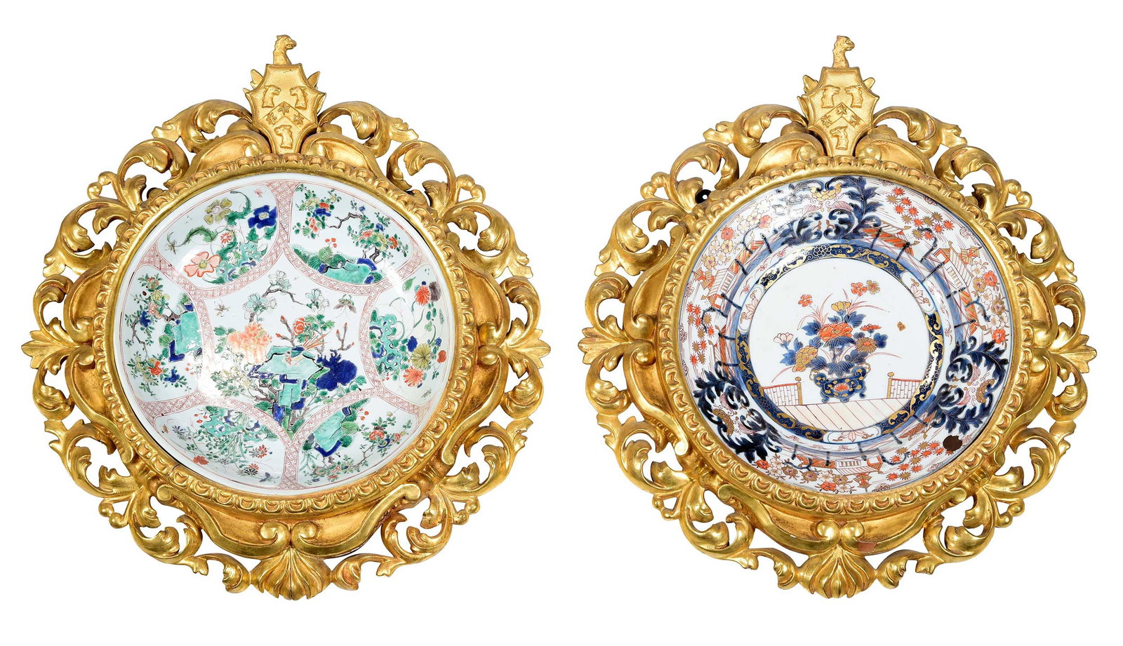 Two Chinese Porcelain Chargers in Gilt Wood Armorial Wall Mounts: 19th century, comprising: gilt imari charger, floral and temple motif, double ring mark to base; famille verte charger, floral motif centering on scene with bird, double ring mark and lingzhi fungus