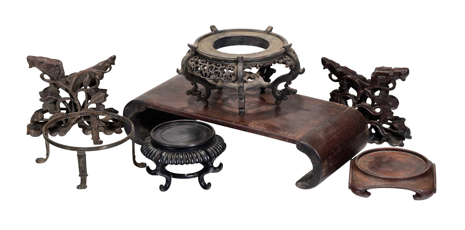 Large Group of Assorted Carved Wood Display Stands: approx. 40 stands of varying size, form, and wood type, largest 3-3/4 x 15 x 7 in. Provenance: The Collection of Joe Matthews and John Shank, Shepherdstown, West Virginia